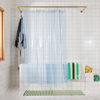 front view of light blue shower curtain hanging in bathroom. 