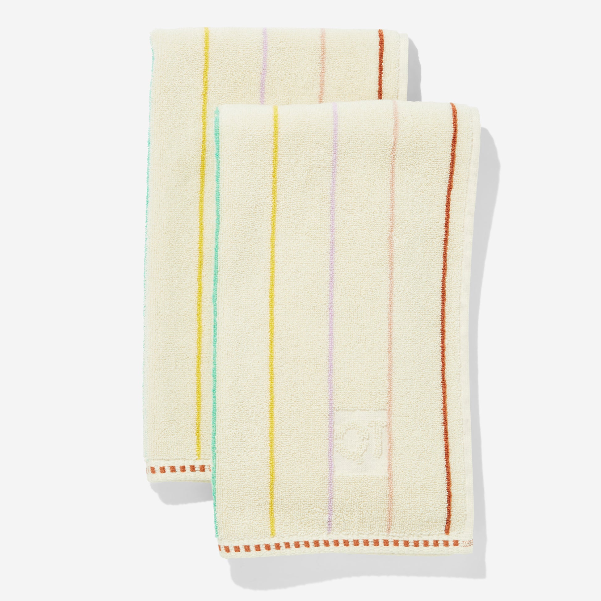 Set of two cream-colored hand towels with colorful stripes on a white background