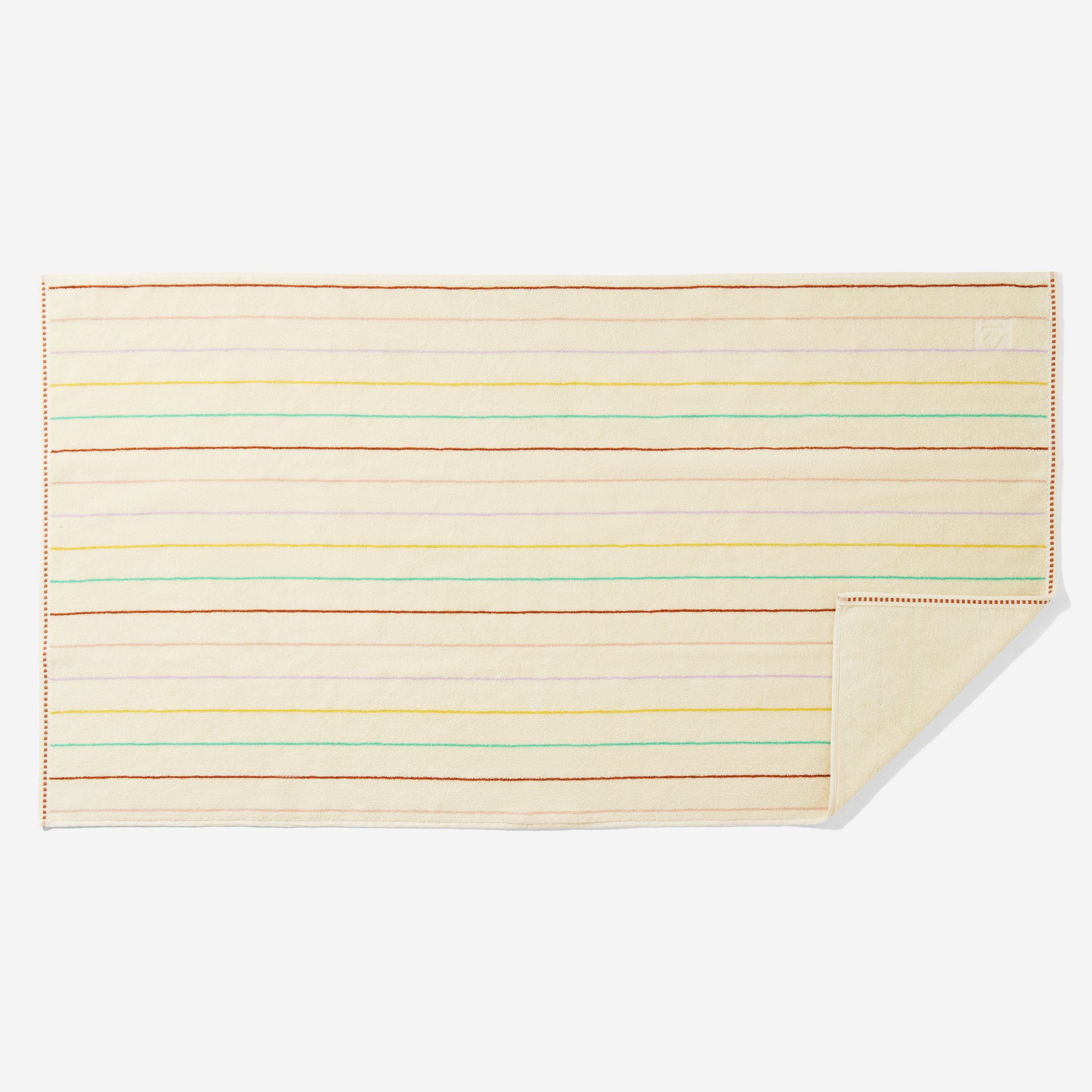 Prism bath towel laid flat with horizontal multi-colored pin stripes. One corner flipped up to show blank side. 