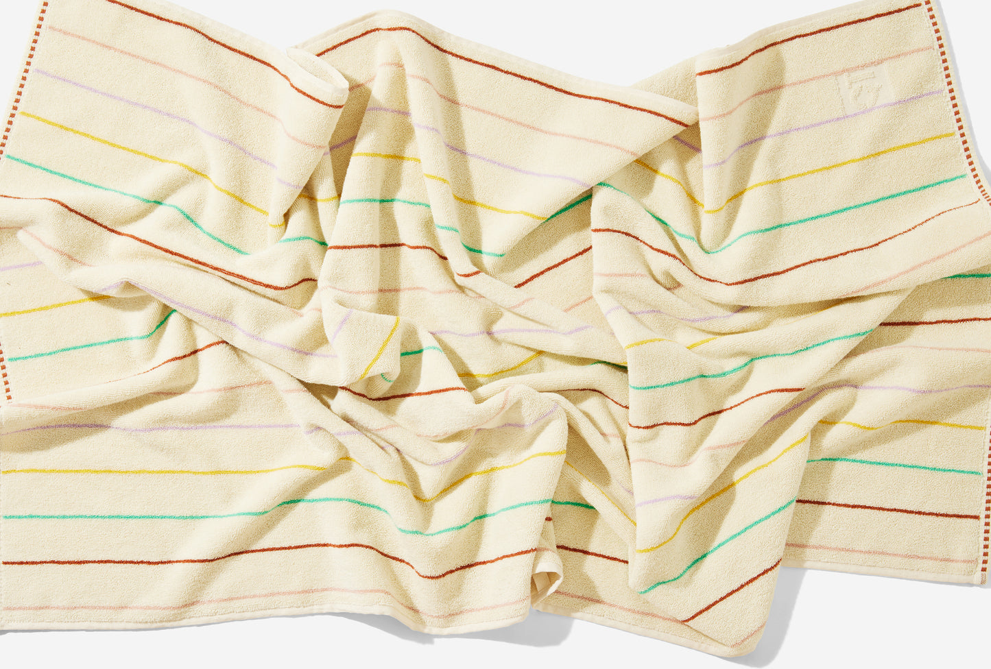 Scrunched up view of the prism bath towel laid on the floor. 
