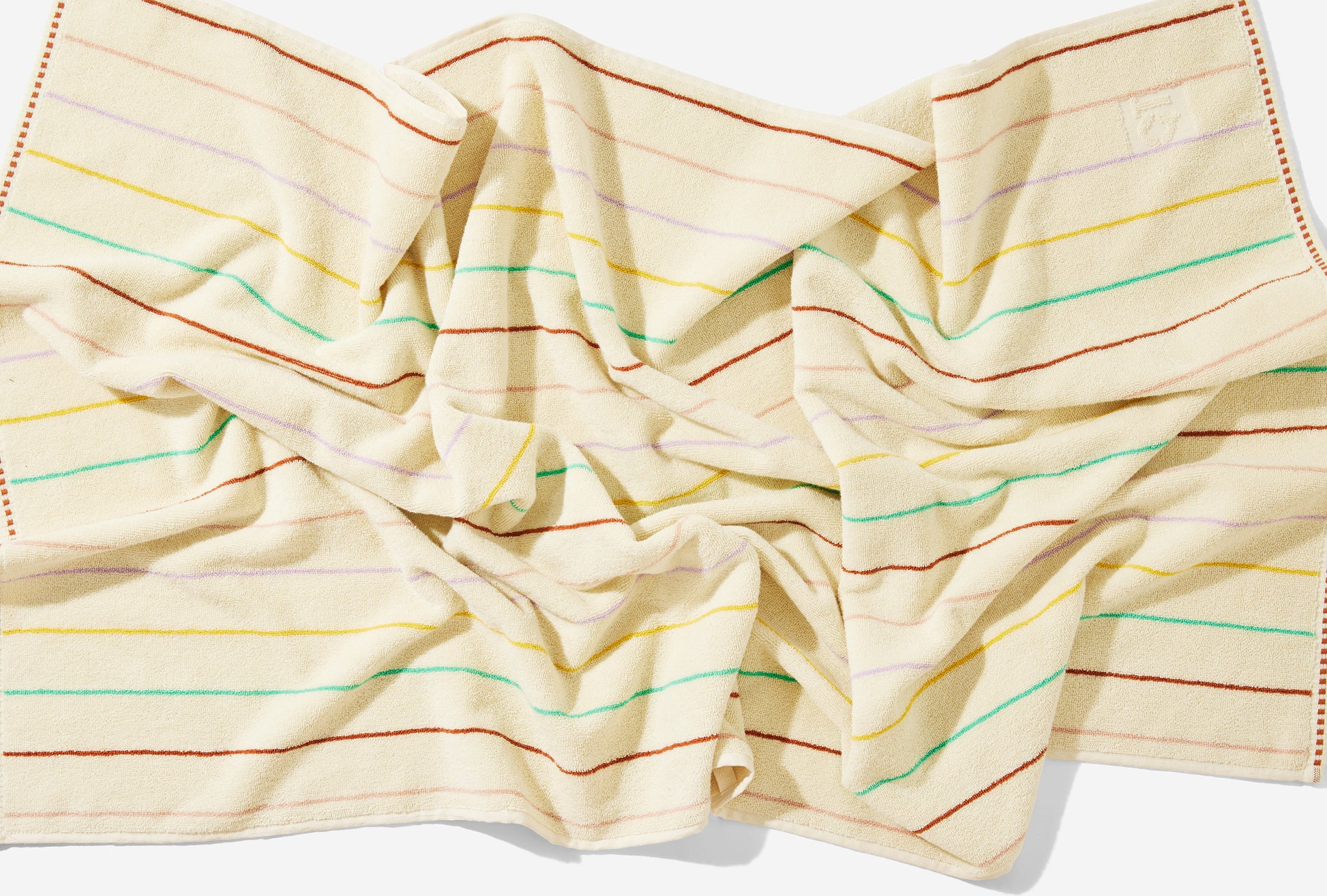 Scrunched up view of the prism bath towel laid on the floor. 