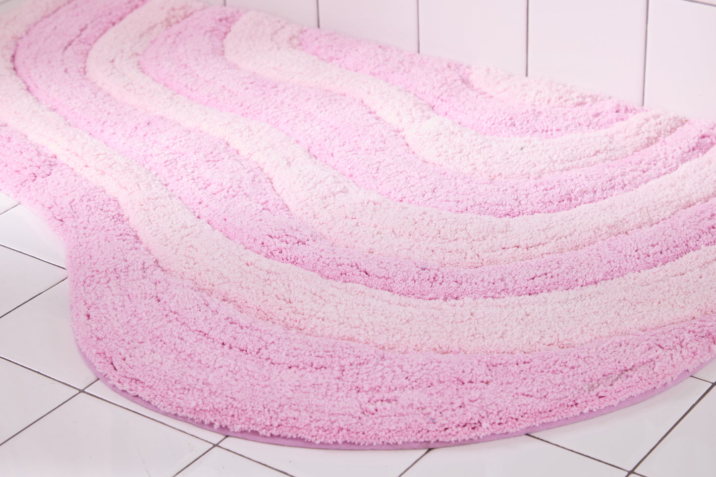 Pink and light pink wavy rug on a tiled floor