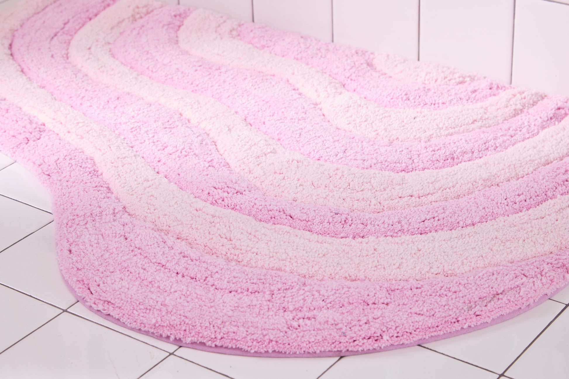 Pink and light pink wavy rug on a tiled floor