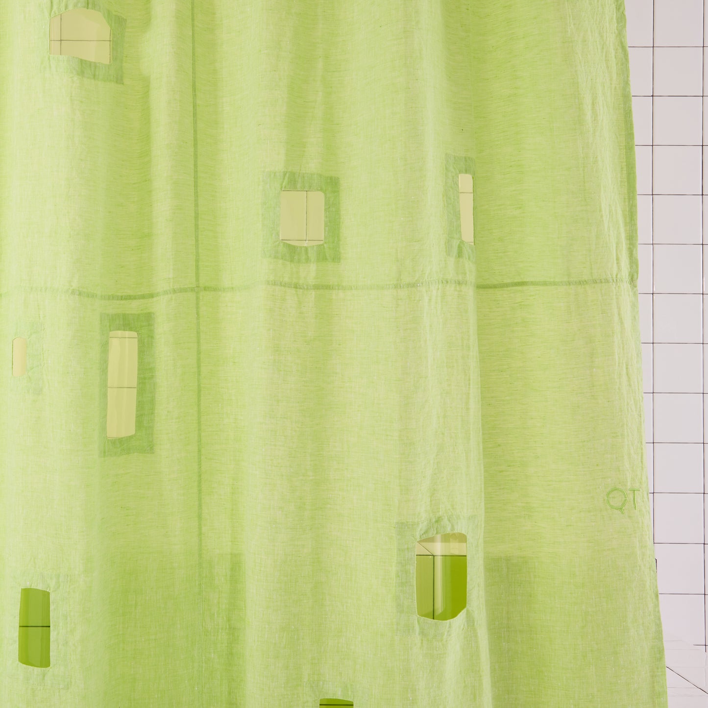bright green curtain with cut outs and green liner