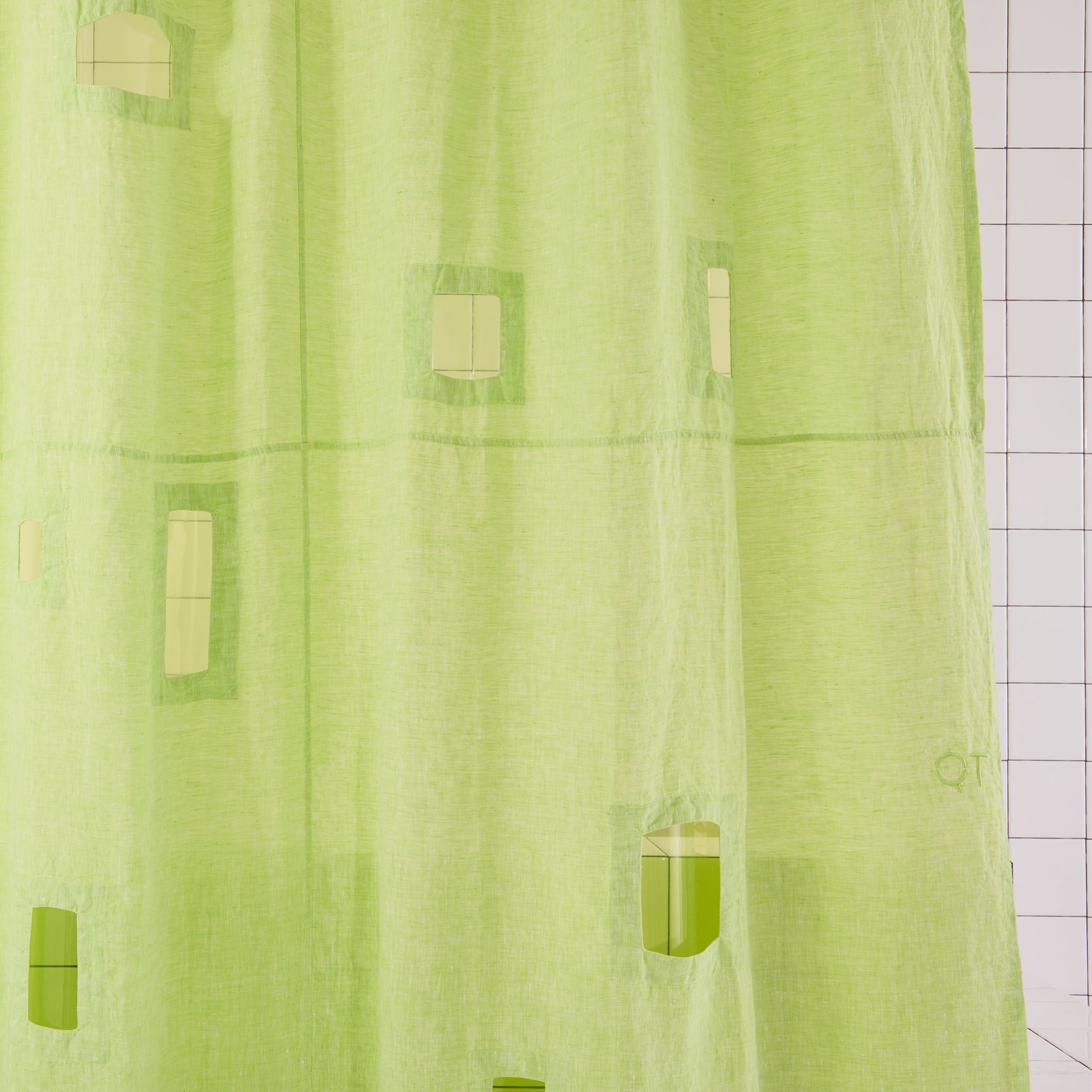 bright green curtain with cut outs and green liner