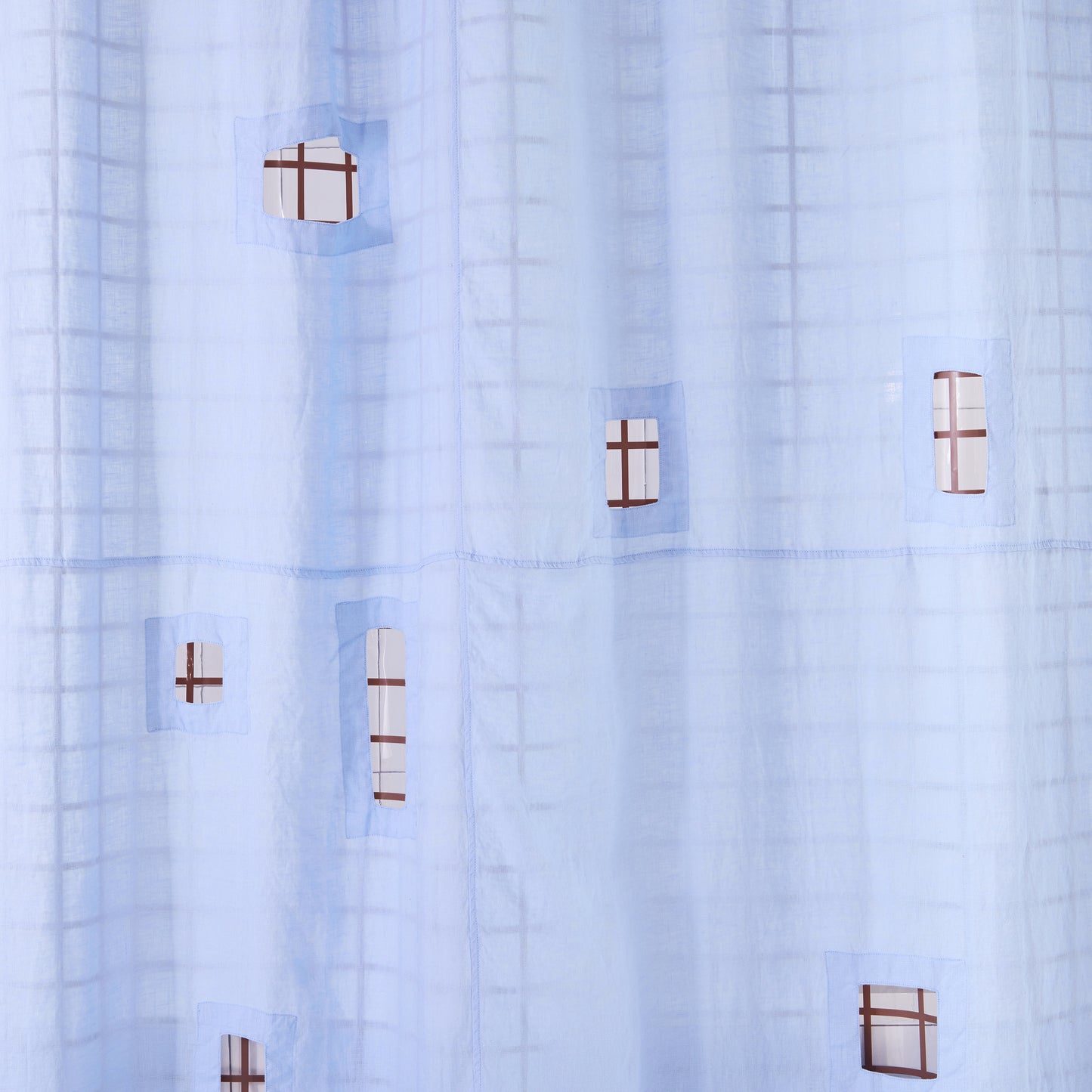 light blue shower curtain with cut outs in a white tiled bathroom.