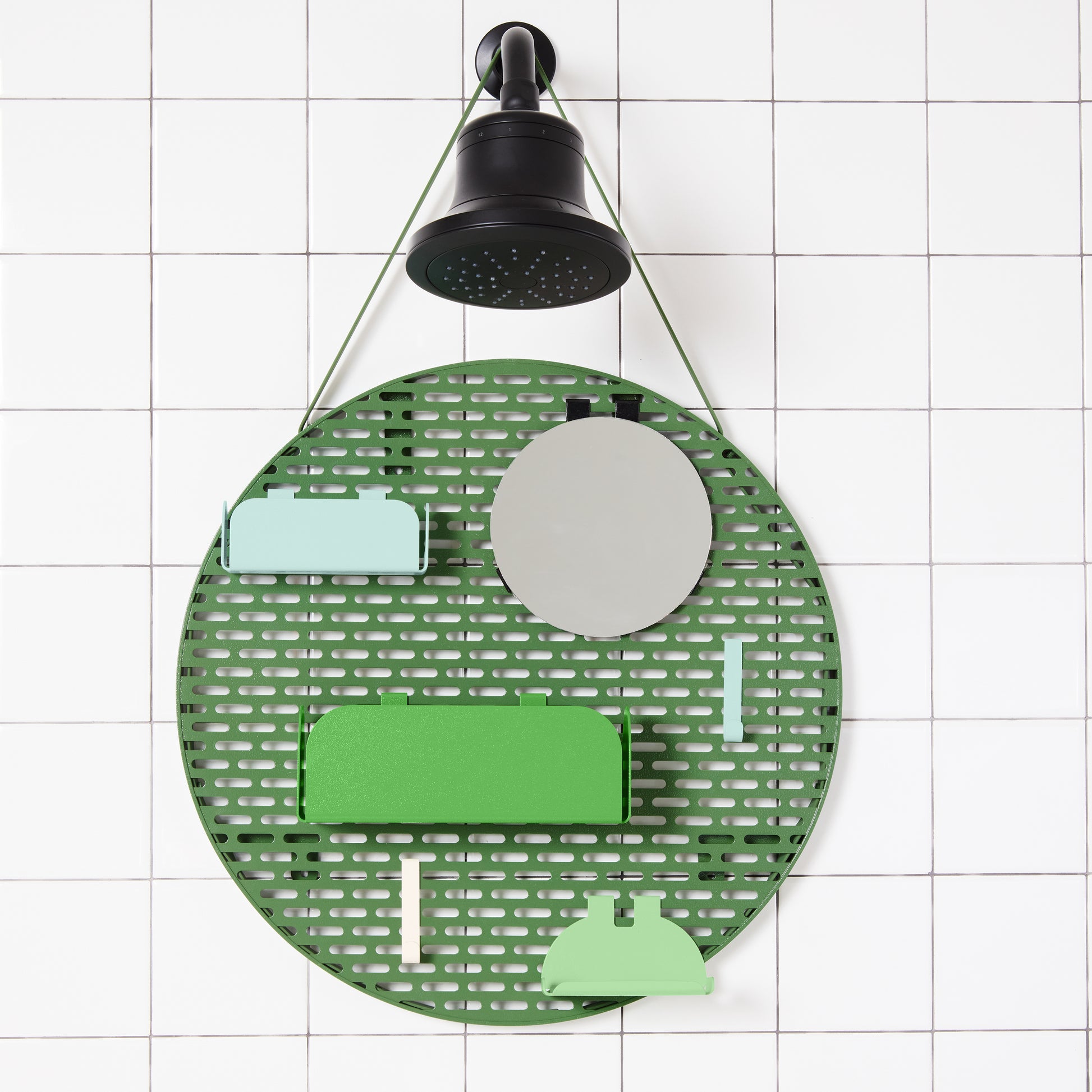 The spot modular shower organizer with shelving pieces arranged hanging in a white tiled shower.