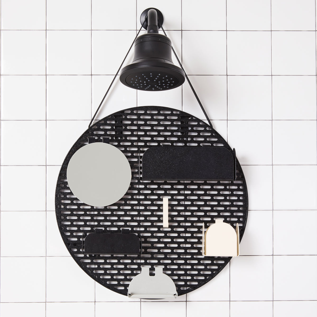 The spot modular shower organizer with shelving pieces arranged hanging in a white tiled shower.