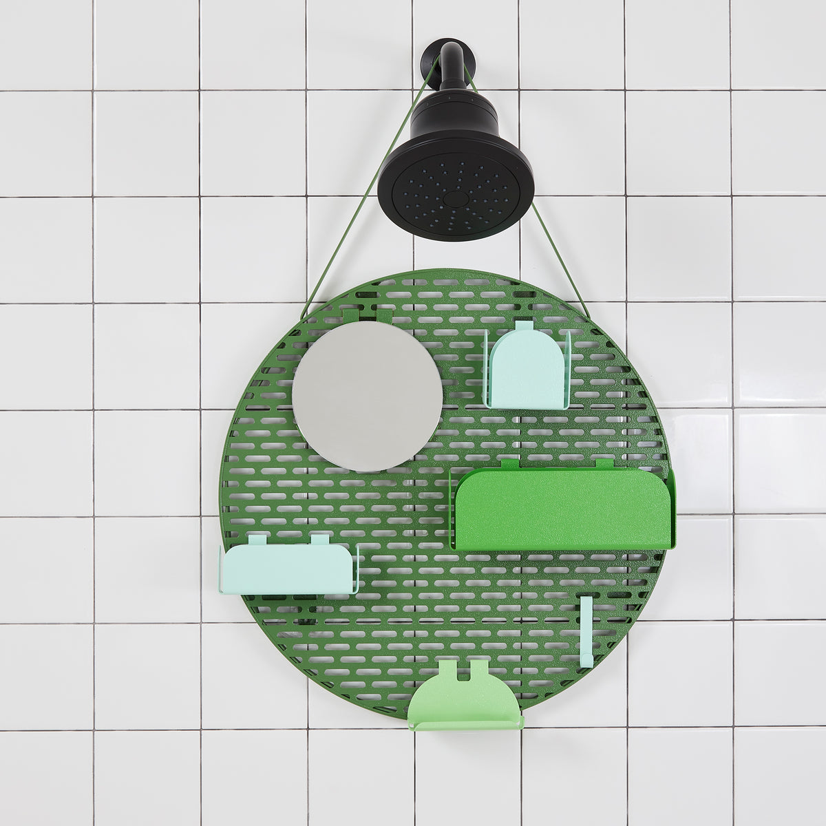 The spot modular shower organizer with shelving pieces arranged hanging in a white tiled shower.