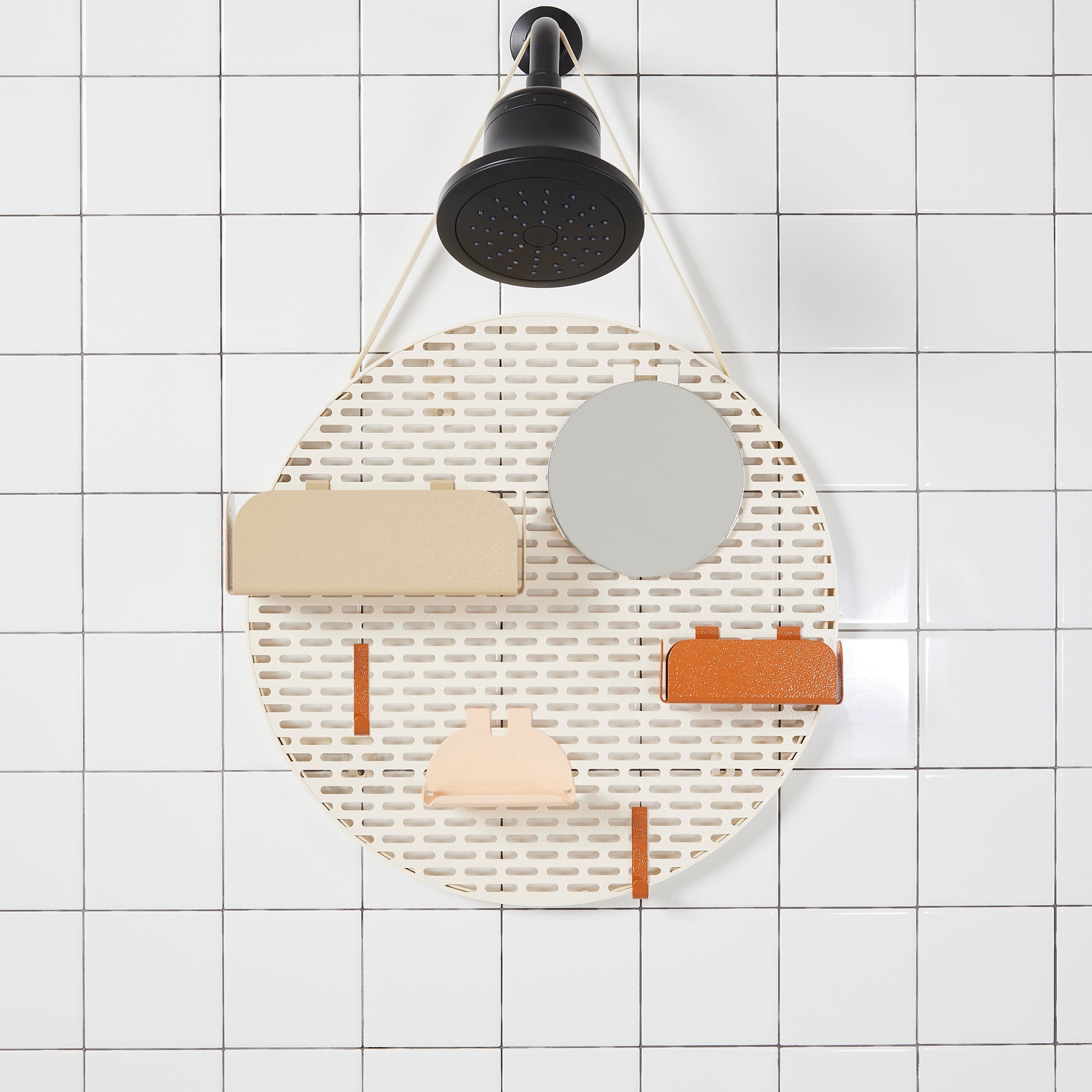 The spot modular shower organizer with shelving pieces arranged hanging in a white tiled shower.