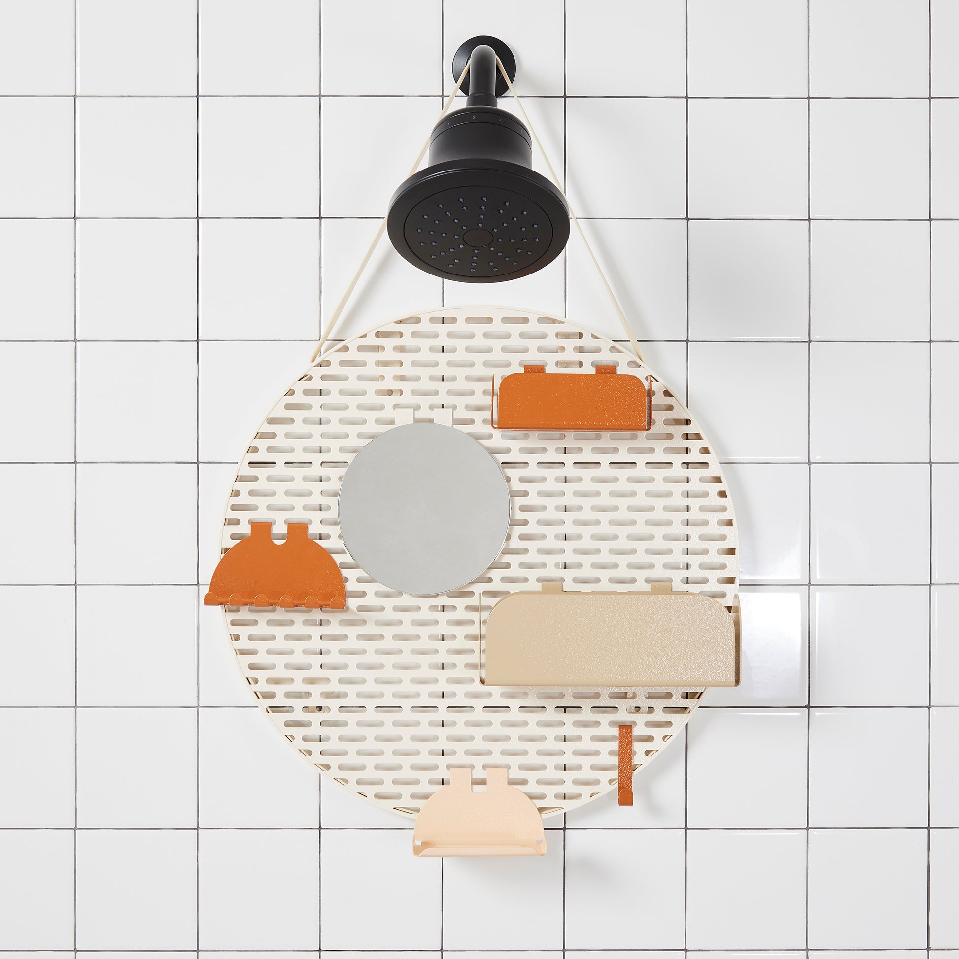 The spot modular shower organizer with shelving pieces arranged hanging in a white tiled shower.