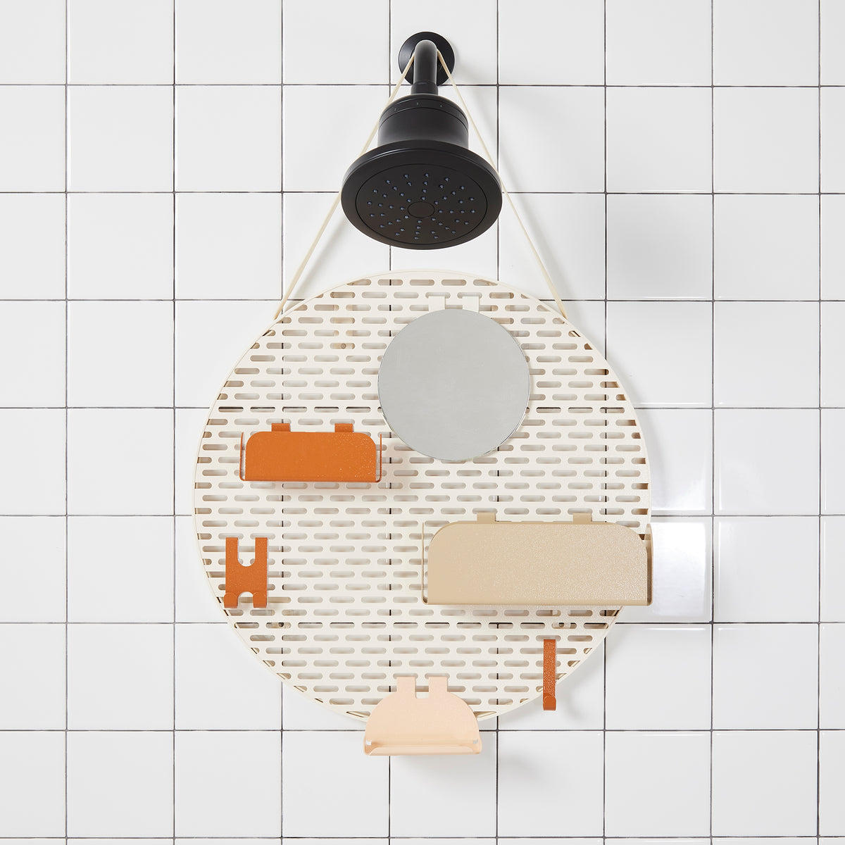 The spot modular shower organizer with shelving pieces arranged hanging in a white tiled shower.
