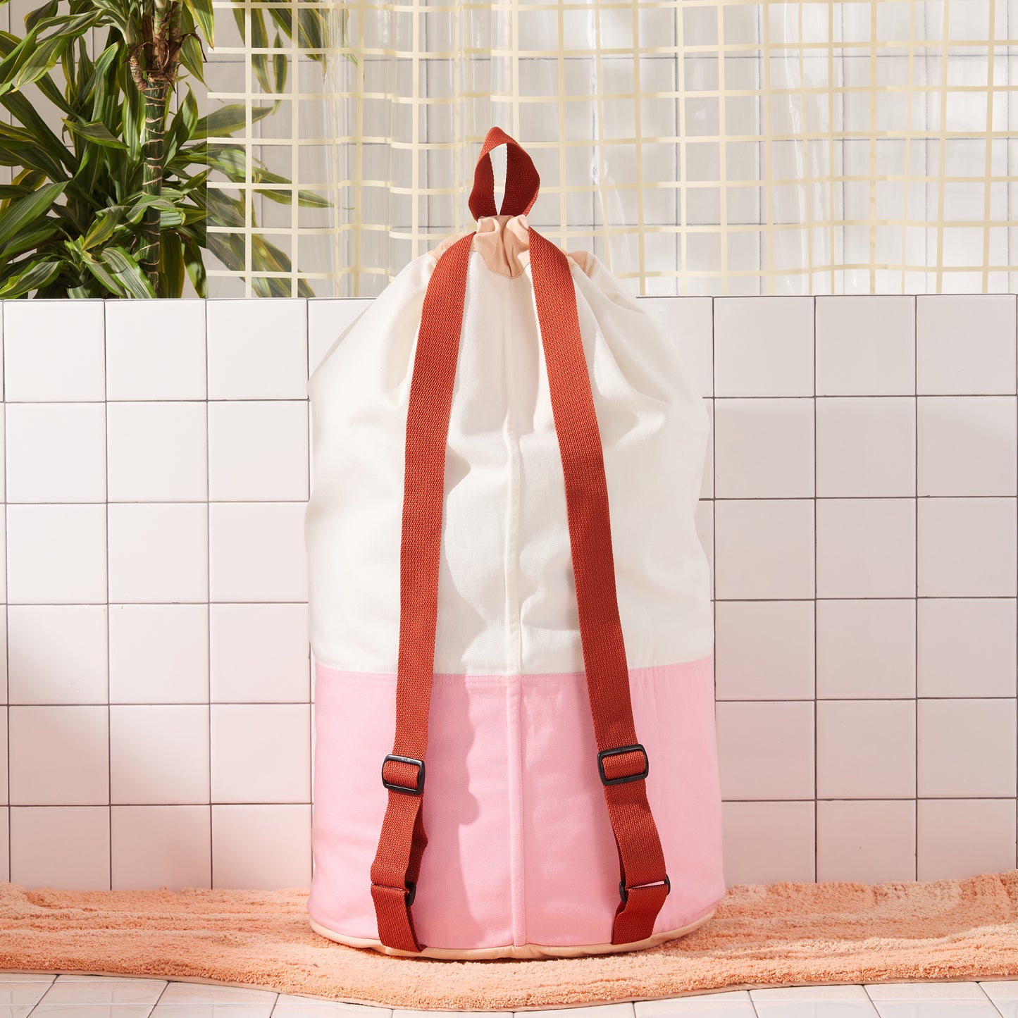 back of laundry bag with burgundy straps. 