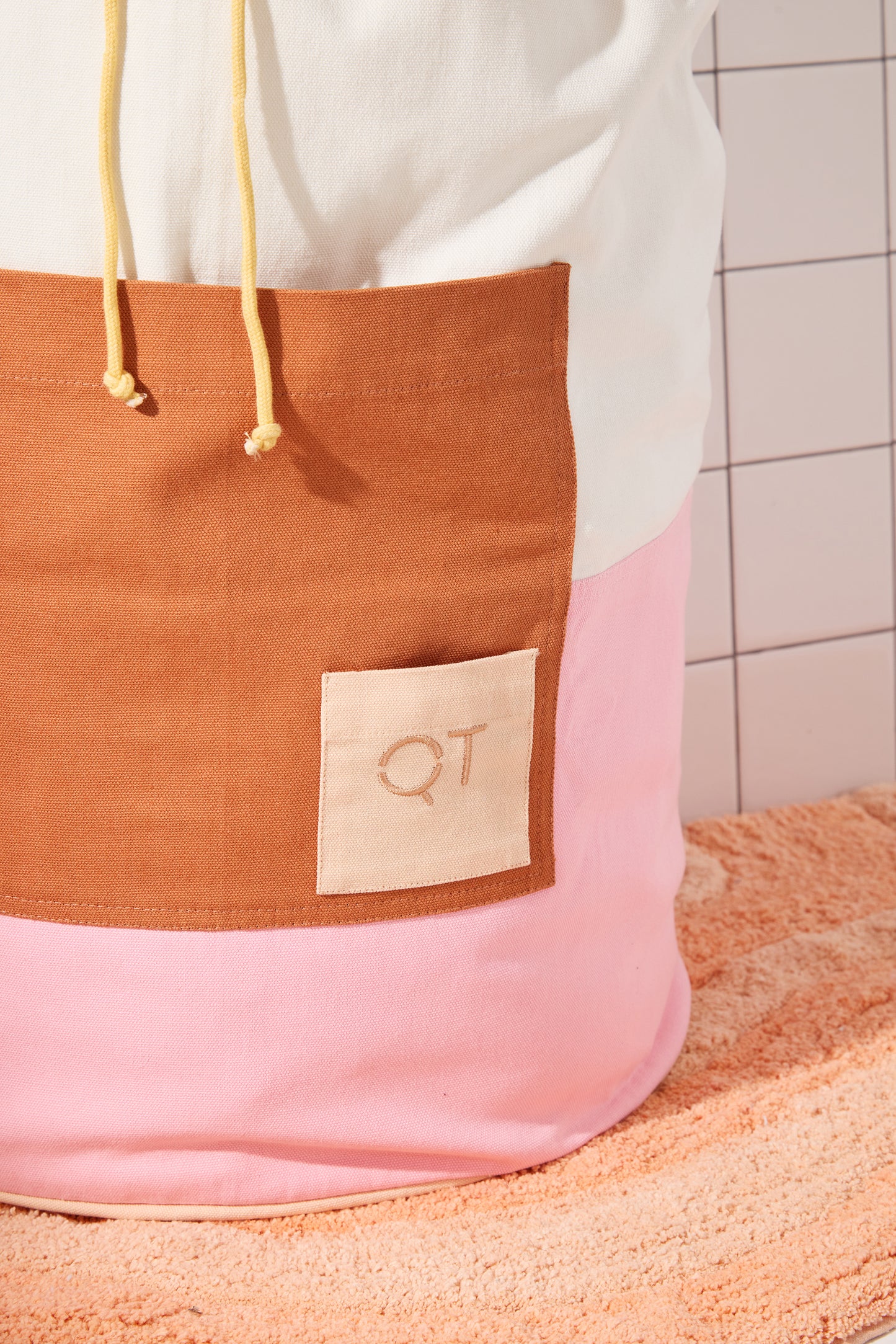 photo of clay colored pocket wtih small peach QT logo pocket. 