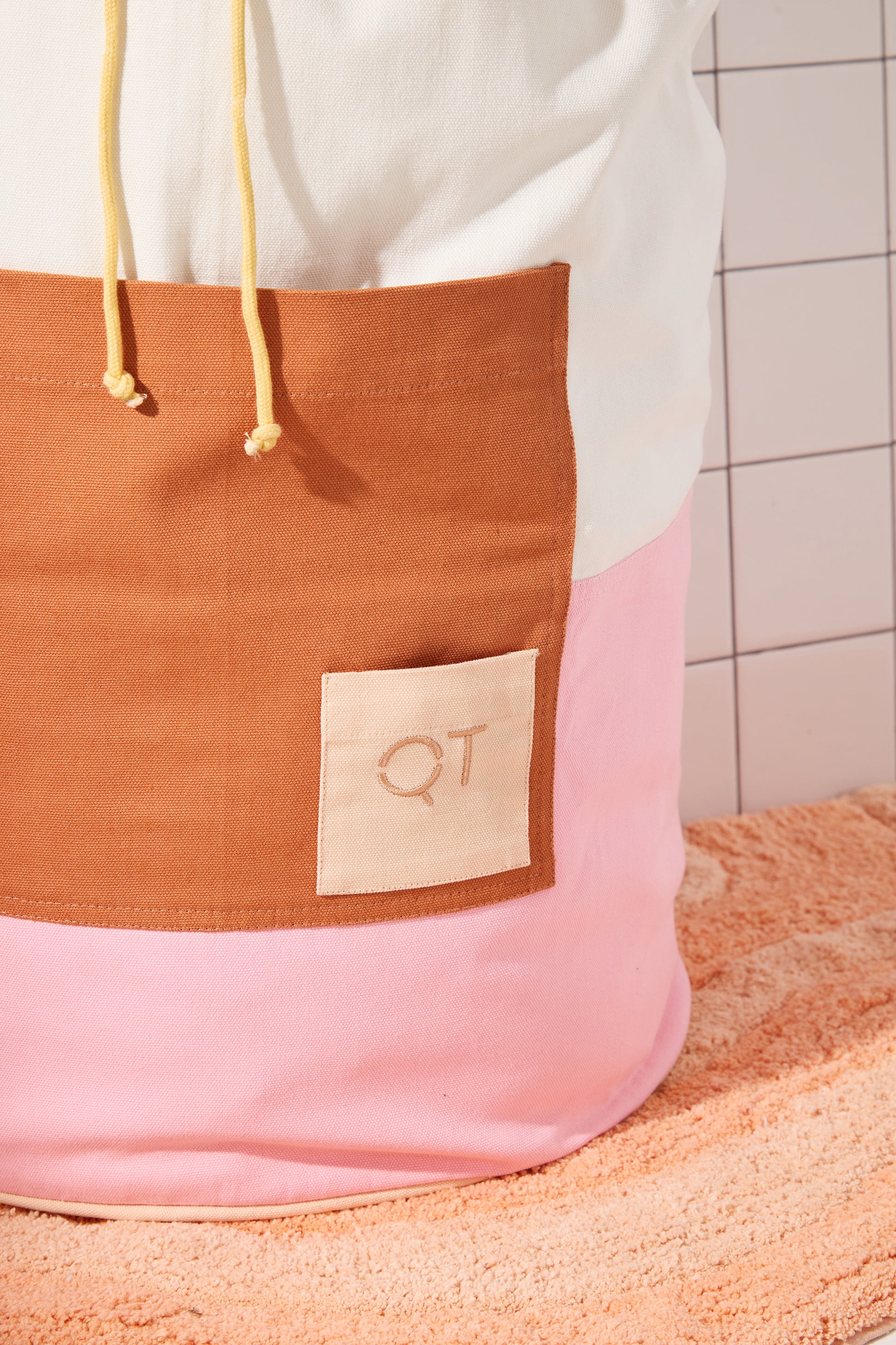 photo of clay colored pocket wtih small peach QT logo pocket. 