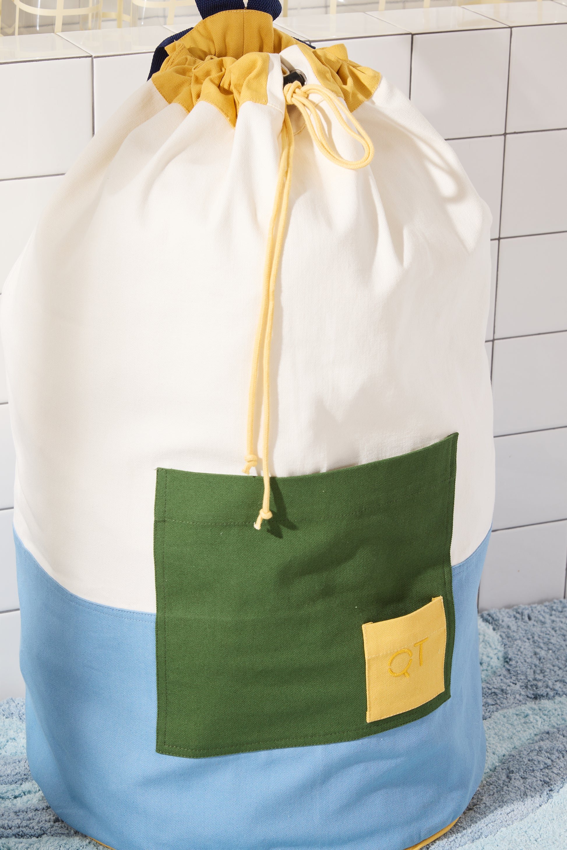 blue and cream bag with large green pocket. 