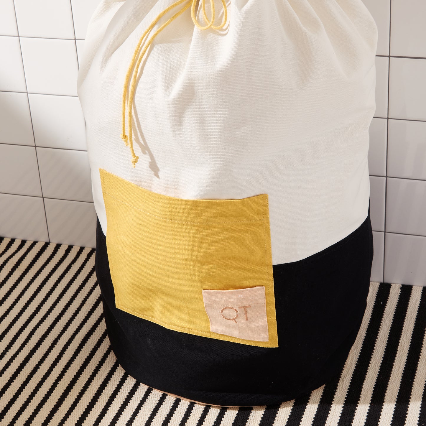 large yellow pocket with small QT logo on pocket