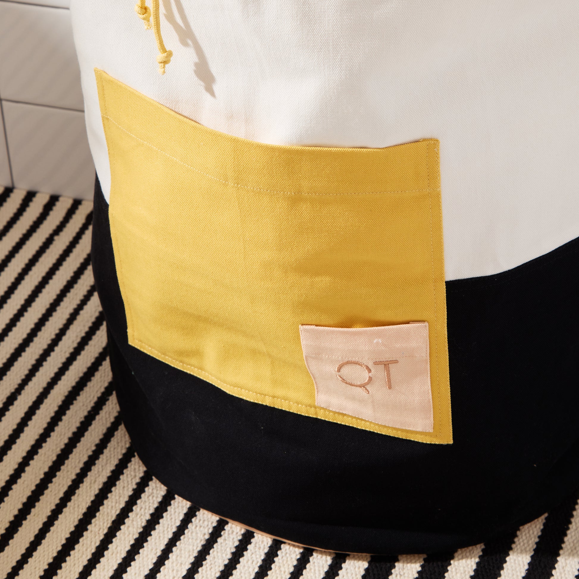 tight crop of large yellow pocket with peach QT logo pocket