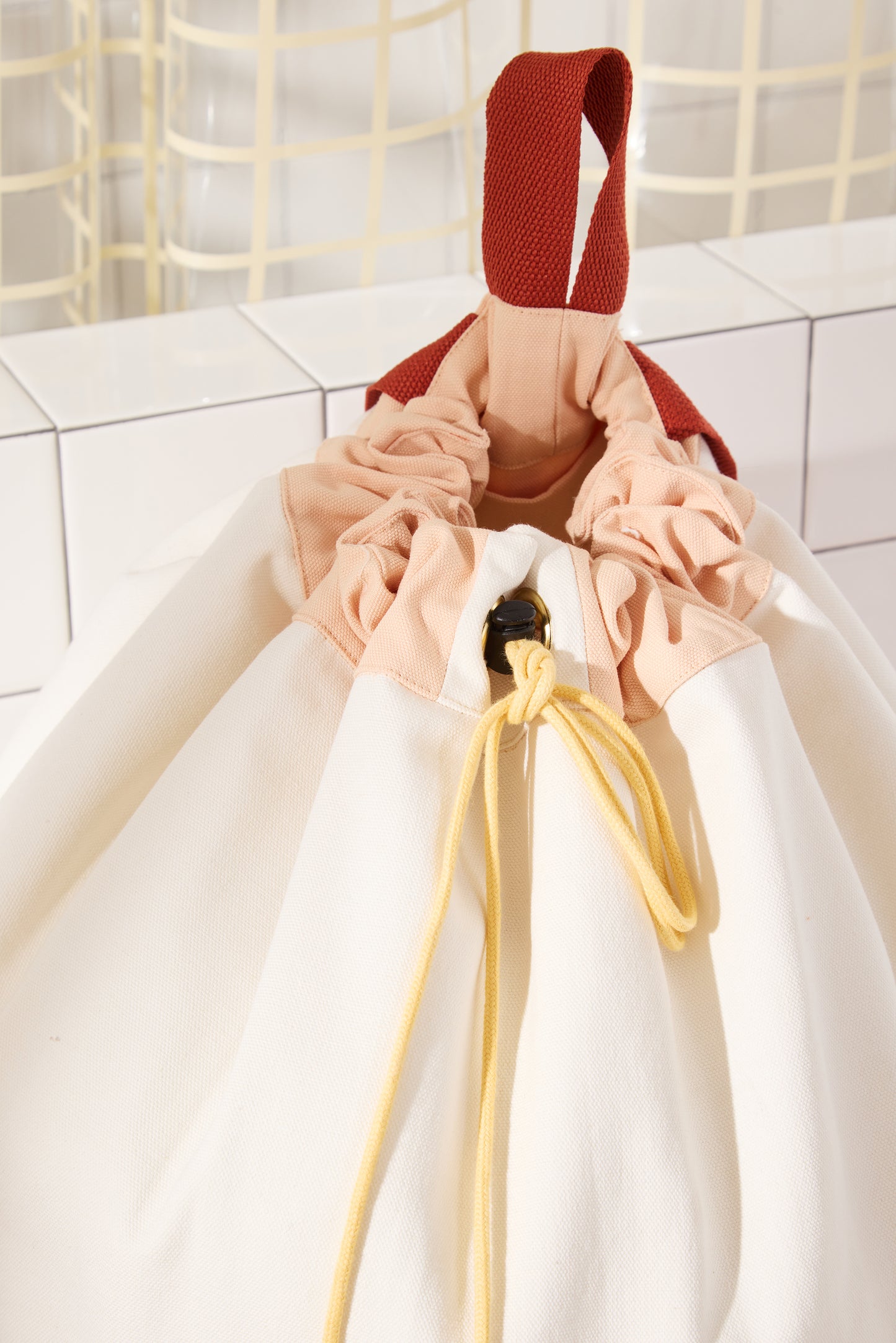 closed top of bag with yellow drawcord. 