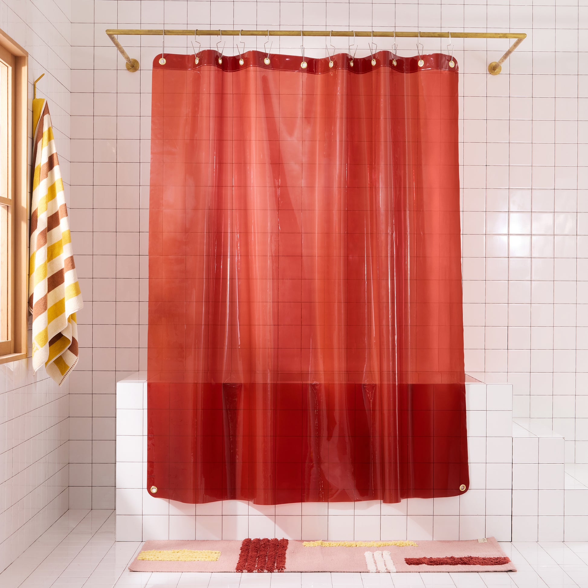 Sun Shower Brick front view of curtain hanging in a white tiled bathroom.