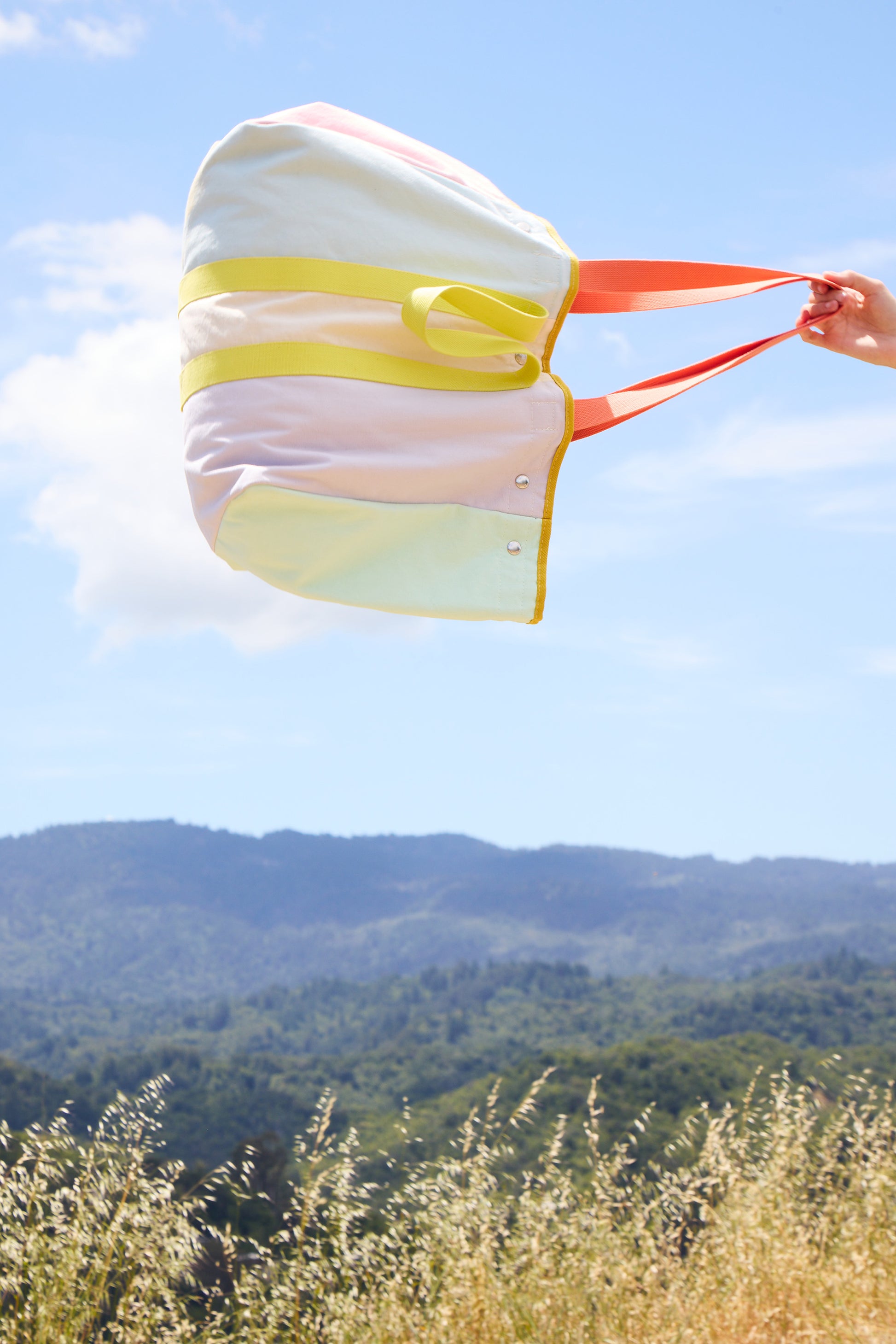 colorful tote bag against a blue sy