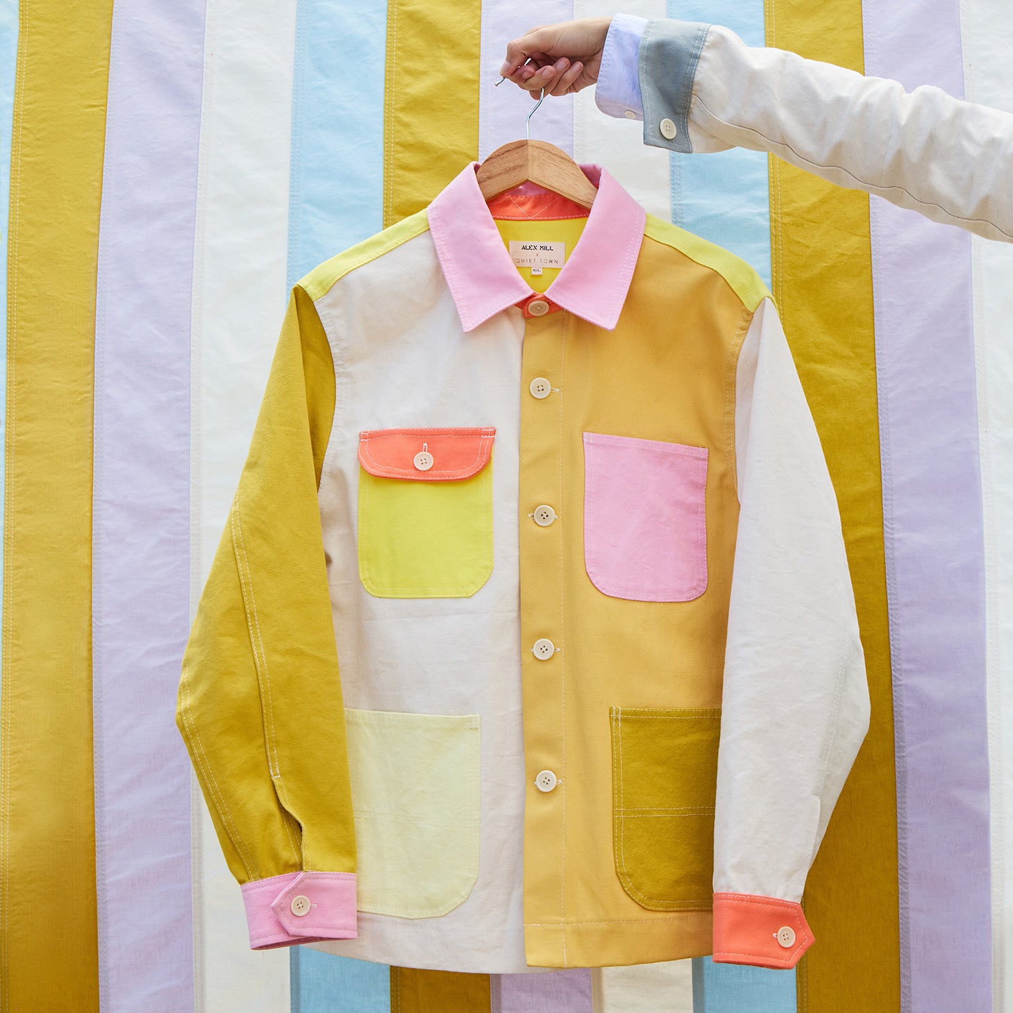 Colorful jacket on a hanger against a striped background