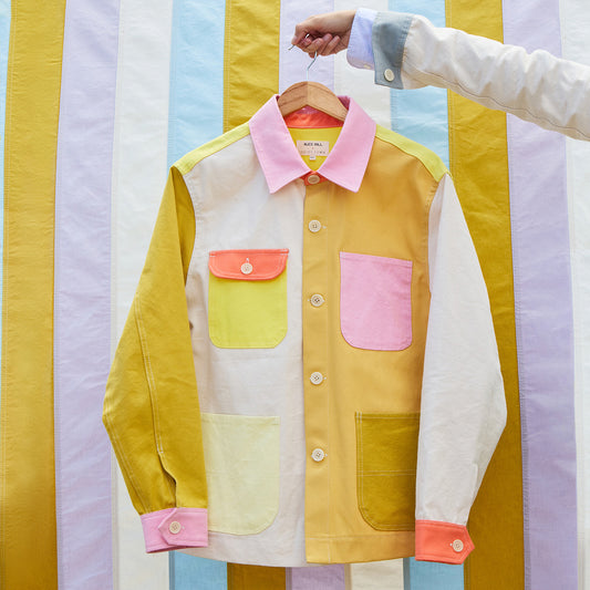 Colorful jacket on a hanger against a striped background
