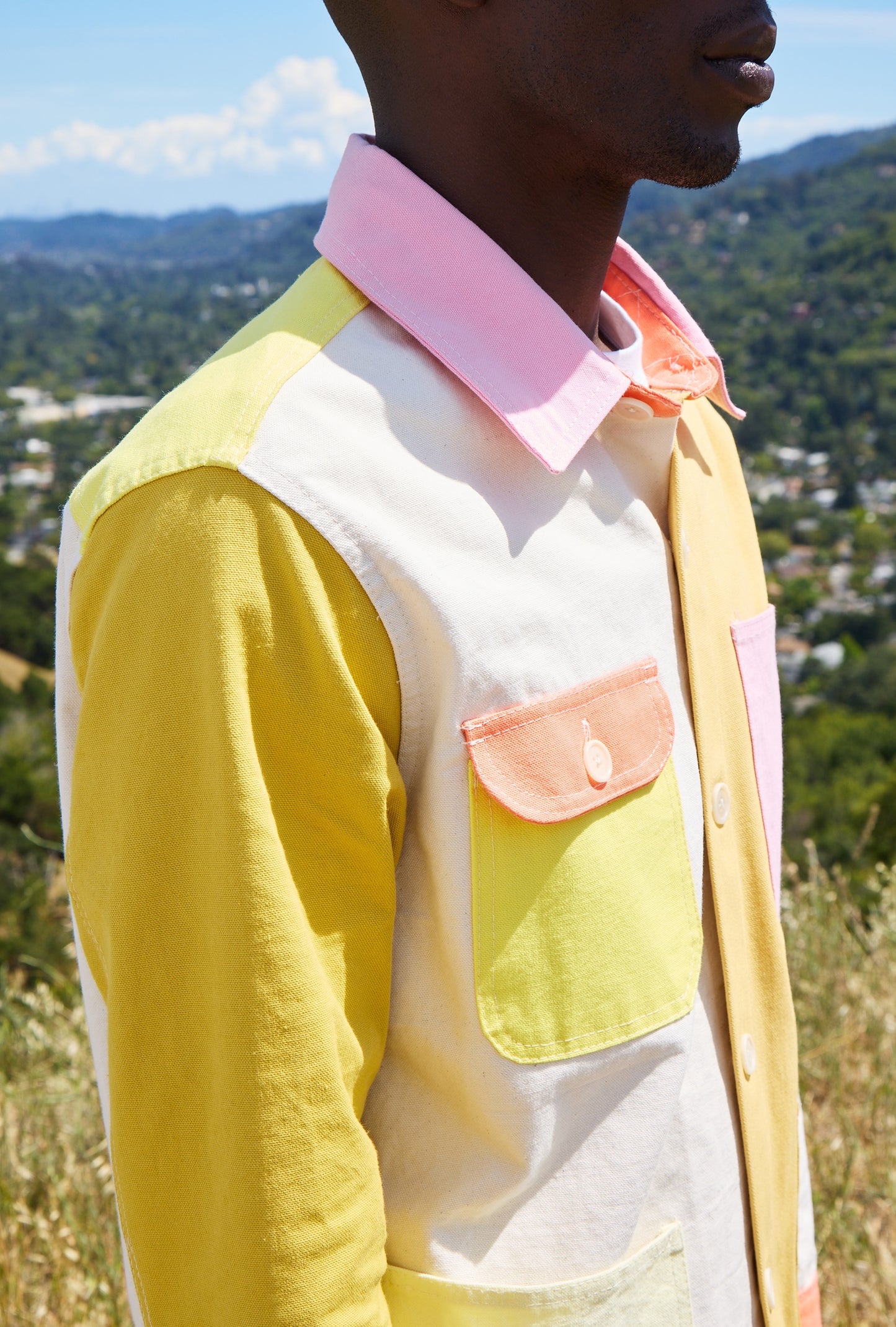 Person wearing a colorful jacket with a scenic background