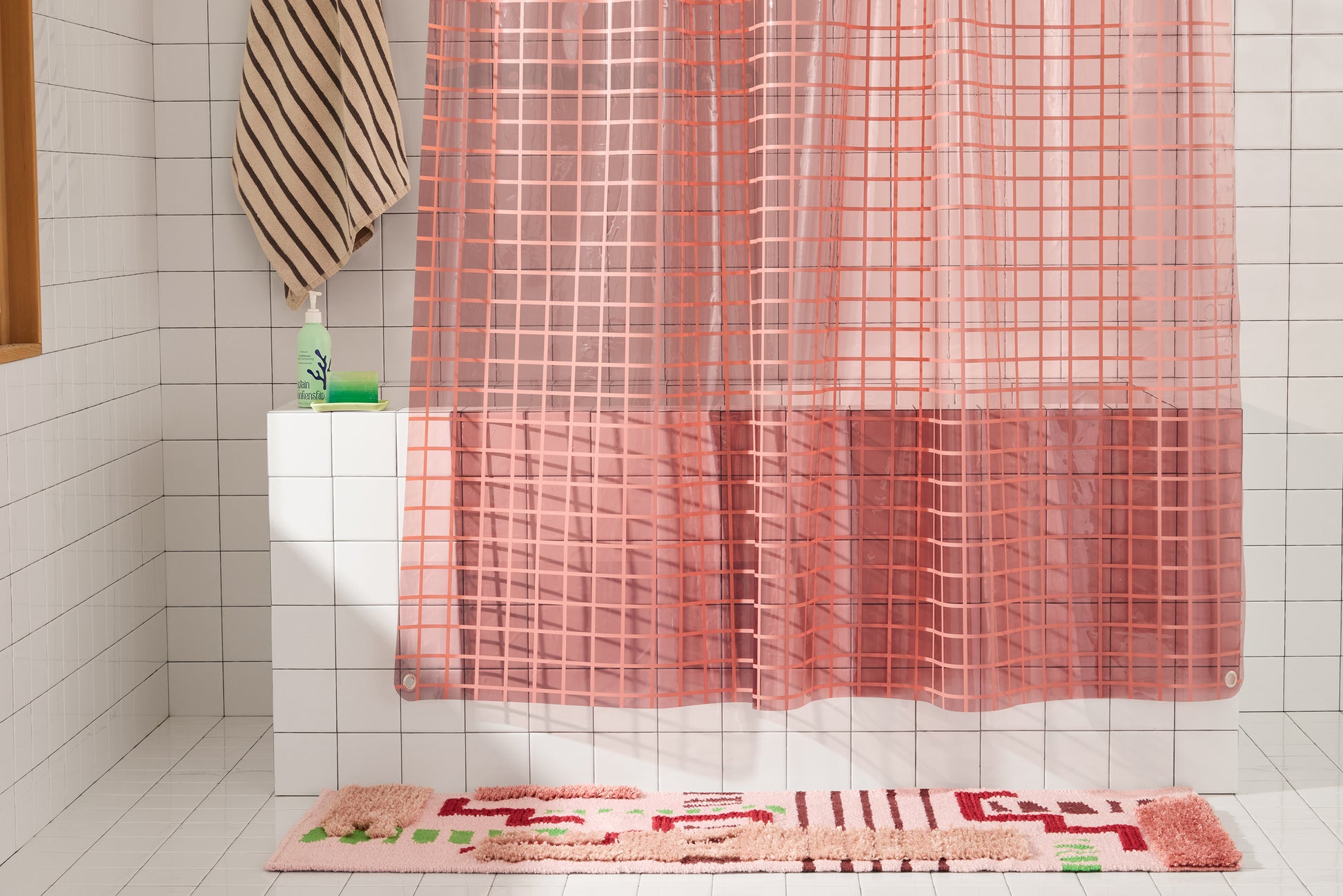 Sun Shower in Rose 2x2 detailed view of bottom of shower curtain hanging in white tiled bathroom. 
