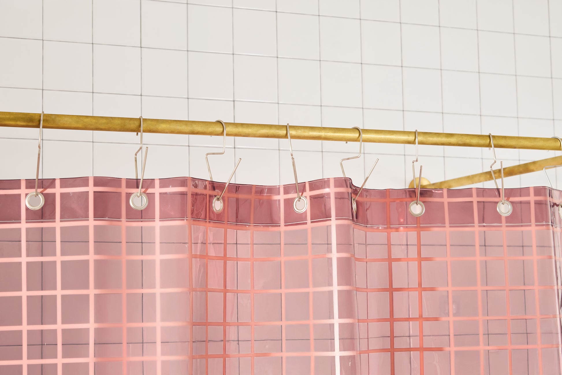 Sun Shower in Rose 2x2 detailed view of top seam hanging from a brass rod from silver venice hooks. 