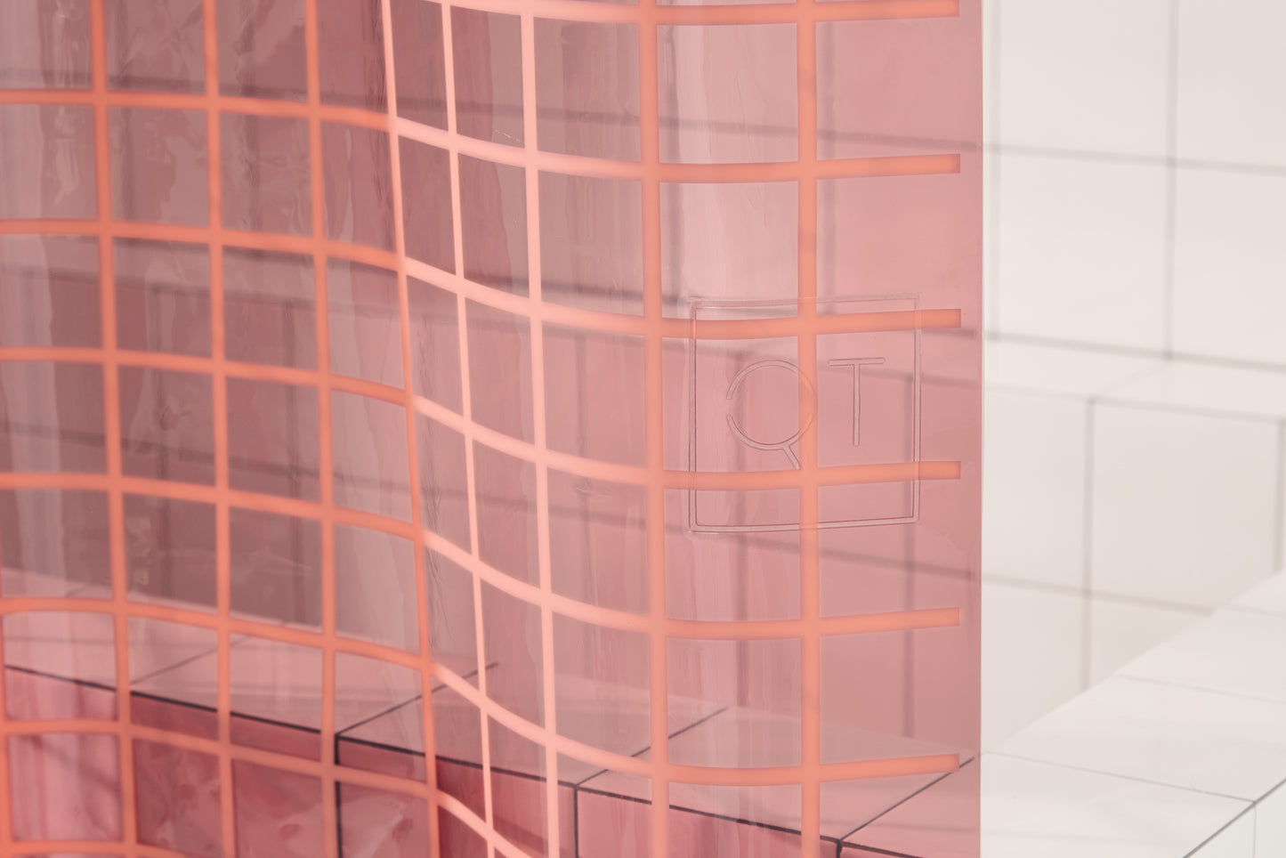 Sun Shower in Rose 2x2 detailed view of embossed QT logo. 