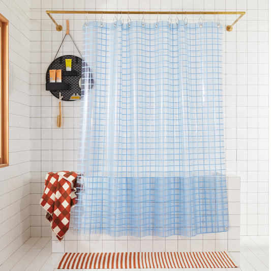 2x2 sun shower curtain in atlantic hanging in a white tiled bathroom. 
