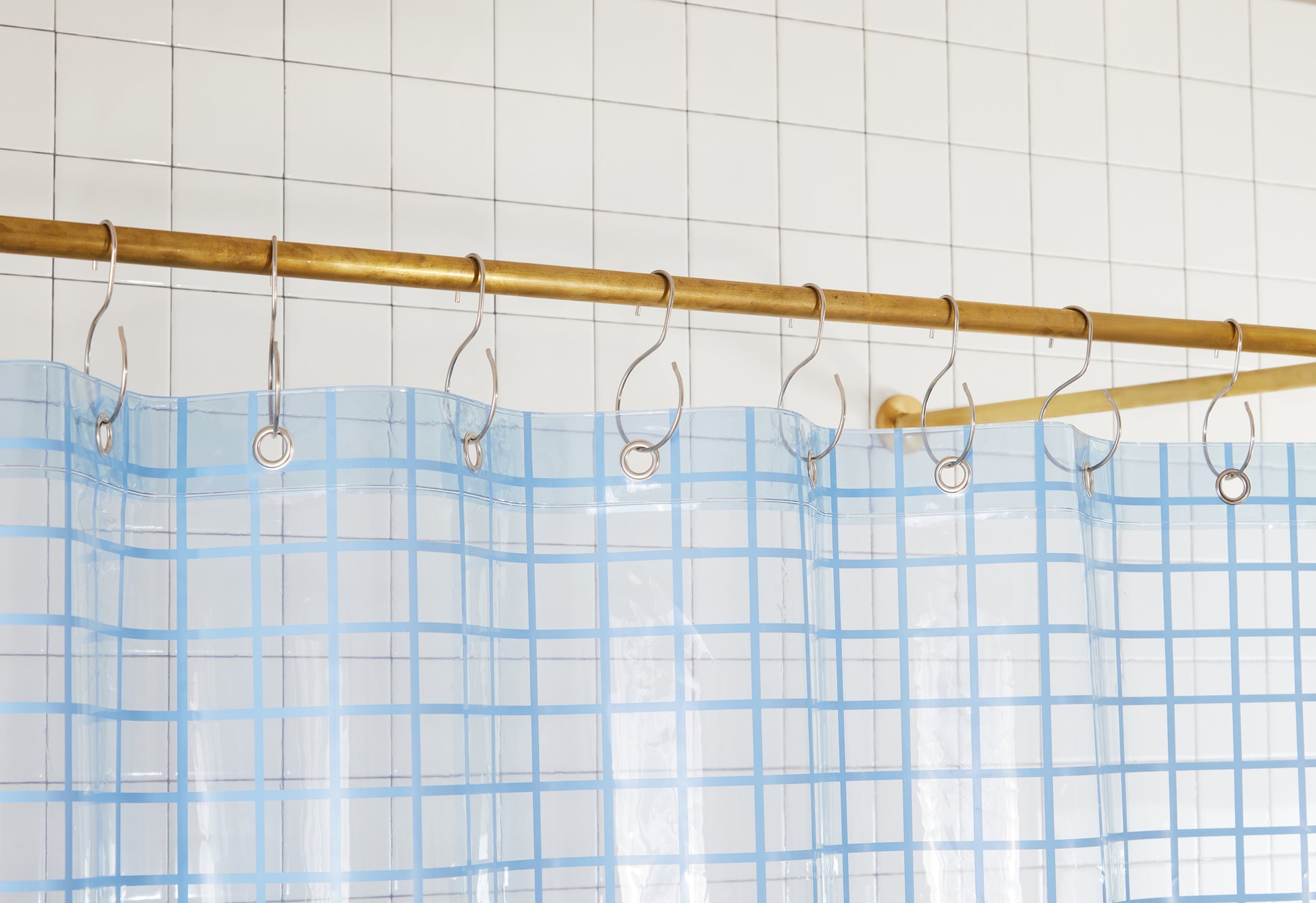Top seam of 2x2 sun shower in atlantic hanging on brass rod from silver S hooks. 