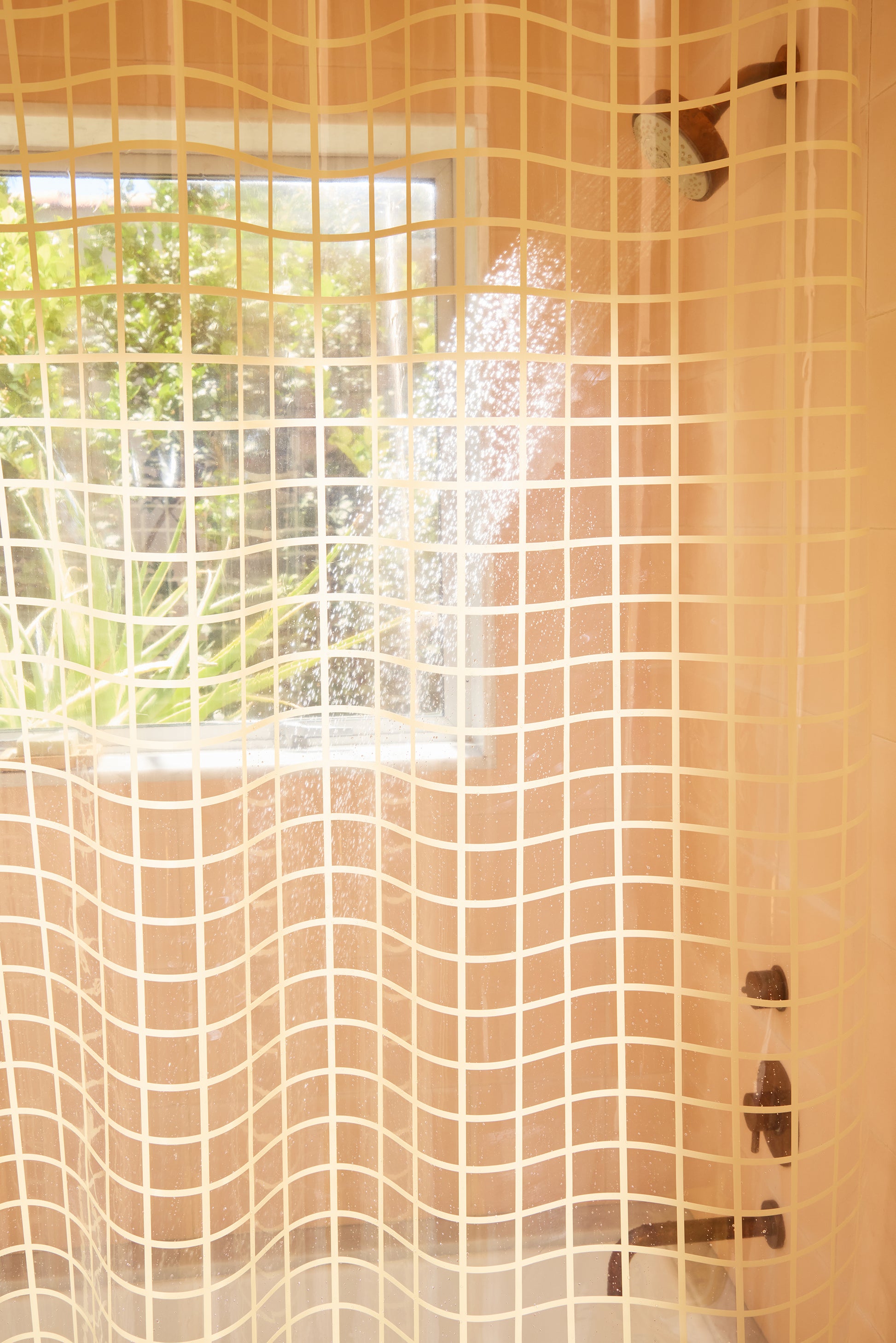 Shower curtain with grid pattern in a bathroom setting