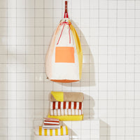 Re:Canvas Laundry Bag Clay Hanging on bathroom wall