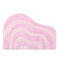 Pink two-toned curvy bath rug with wavy pattern on a white background