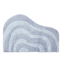 Light blue bath mat with wavy pattern on a white background