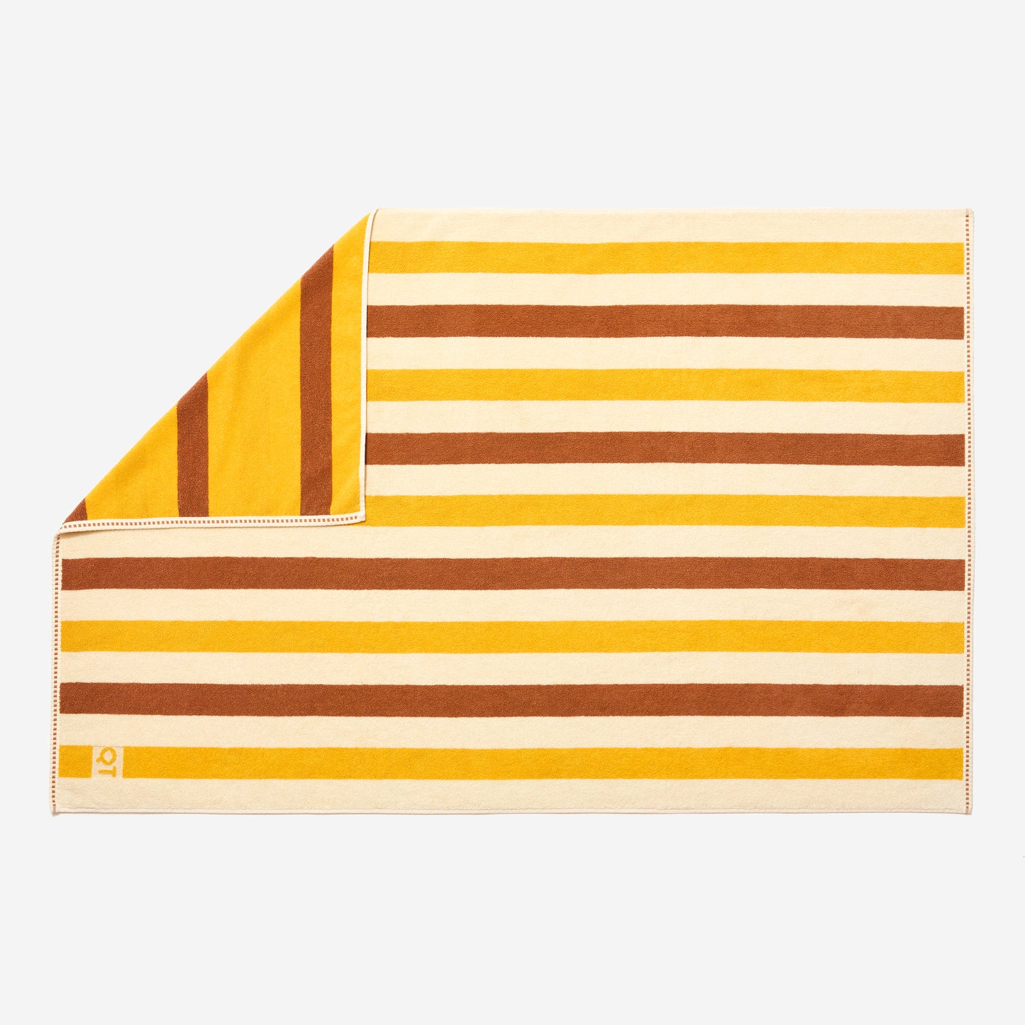 Full view of catalina bath sheet in canyon laid flat with one corner folded up showing double sided stripe pattern. 