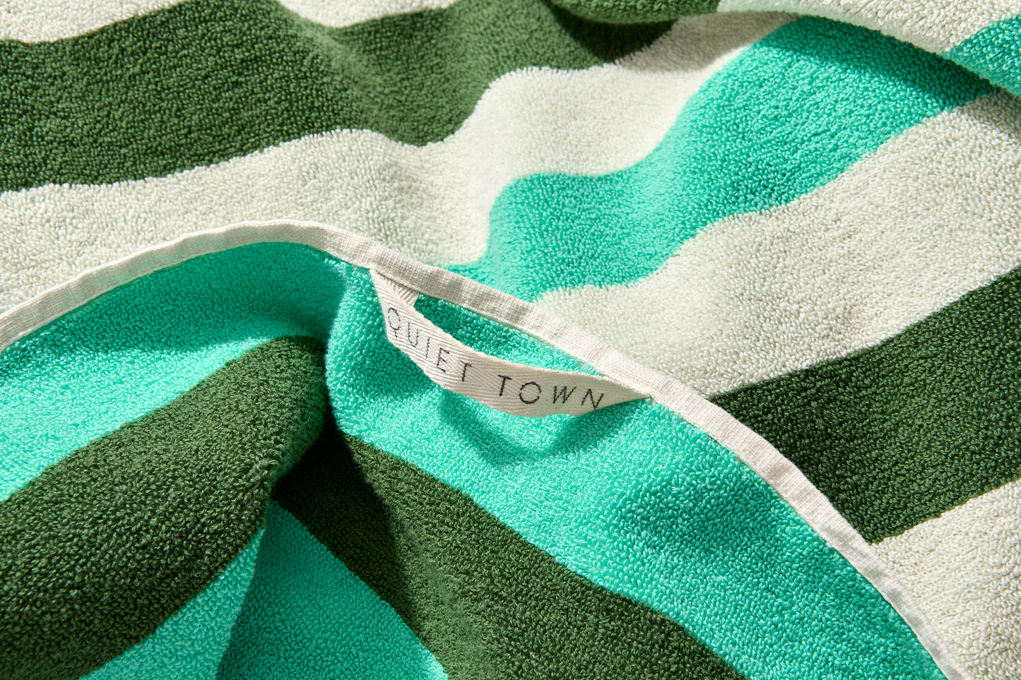 Close up of quiet town hanging loop on catalina bath sheet in pine. 