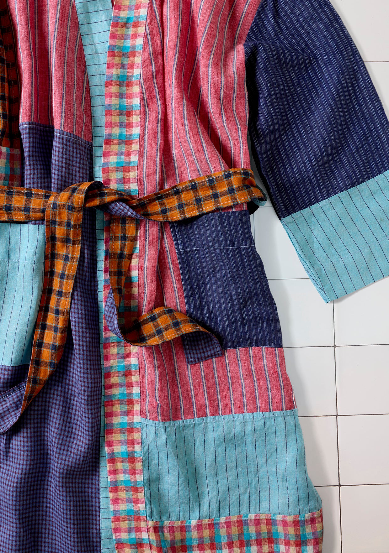 Patchwork robe with colorful patterns on a tiled floor