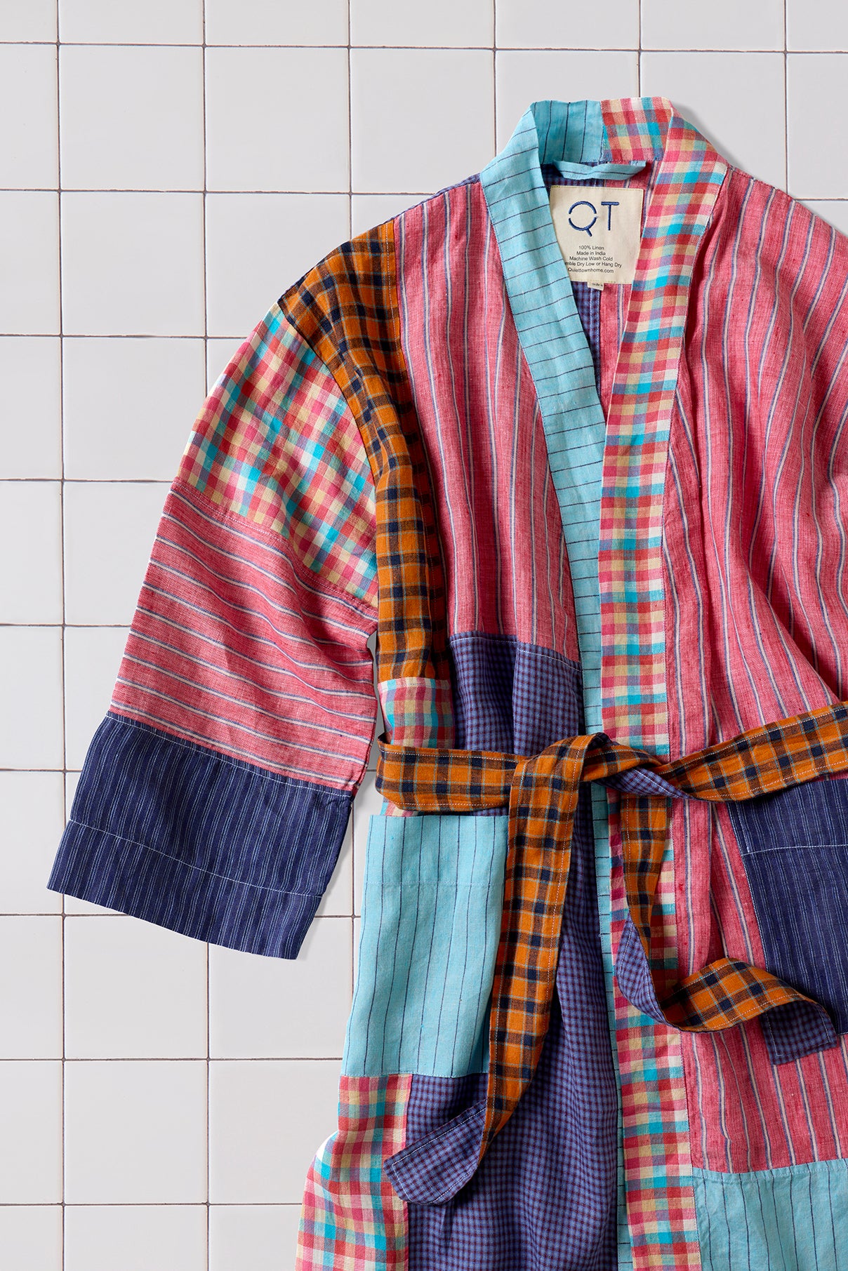 Colorful patchwork robe on a tiled floor