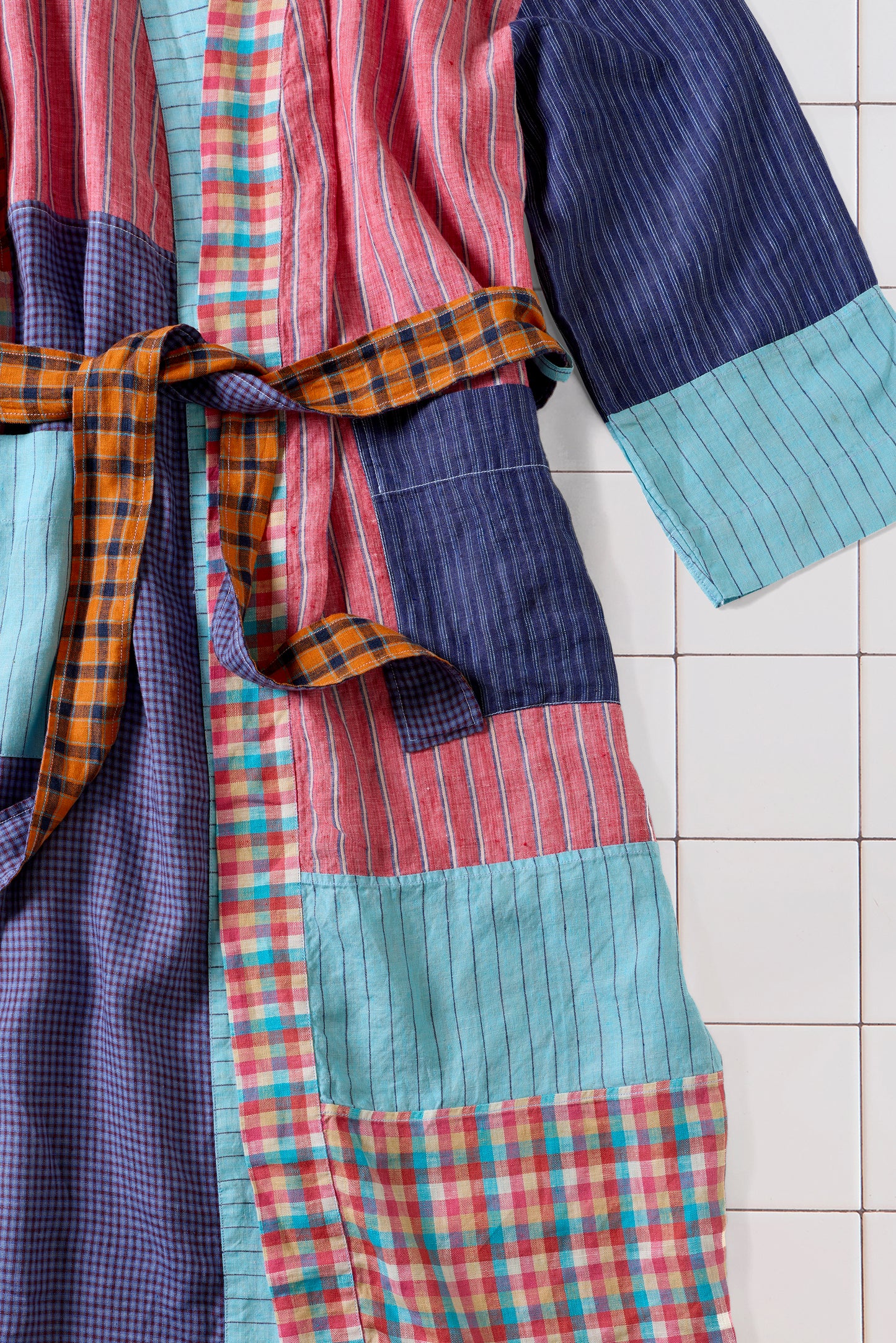 Colorful patchwork robe on a tiled floor