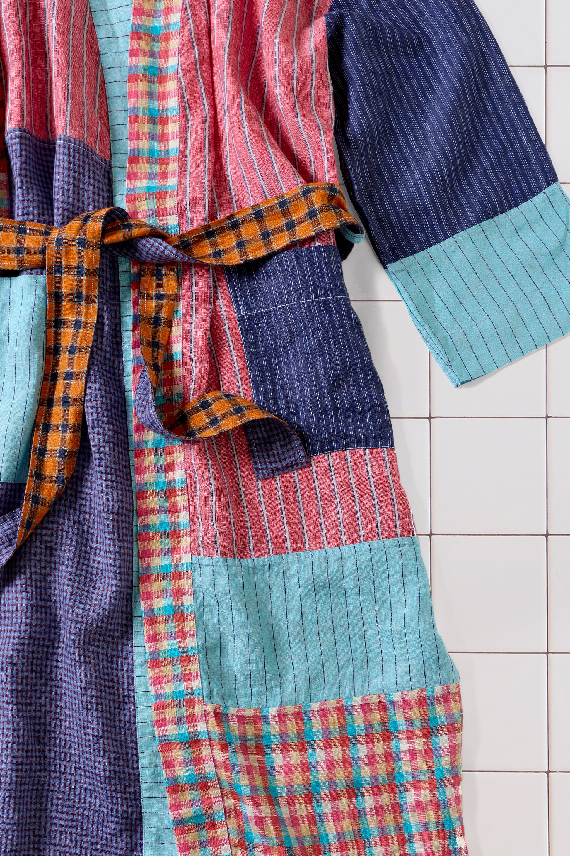 Colorful patchwork robe on a tiled floor