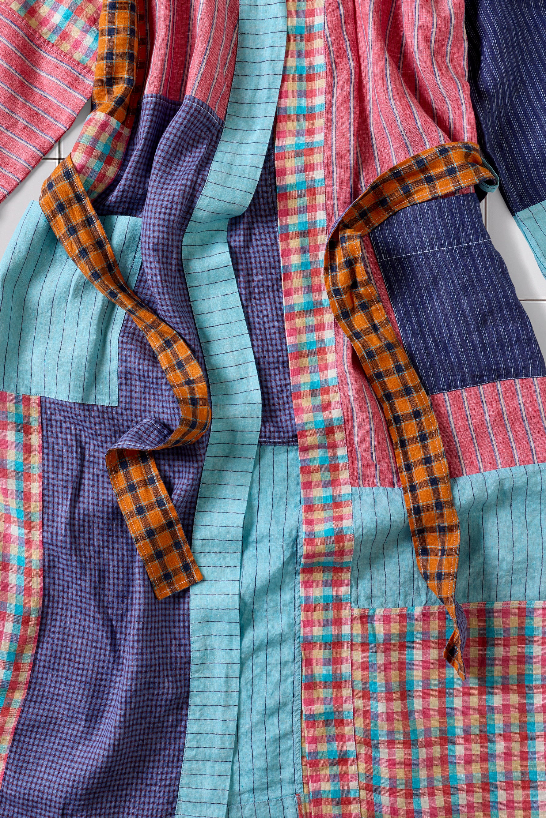 Colorful patchwork robe with plaid patterns featuring an orange belt.