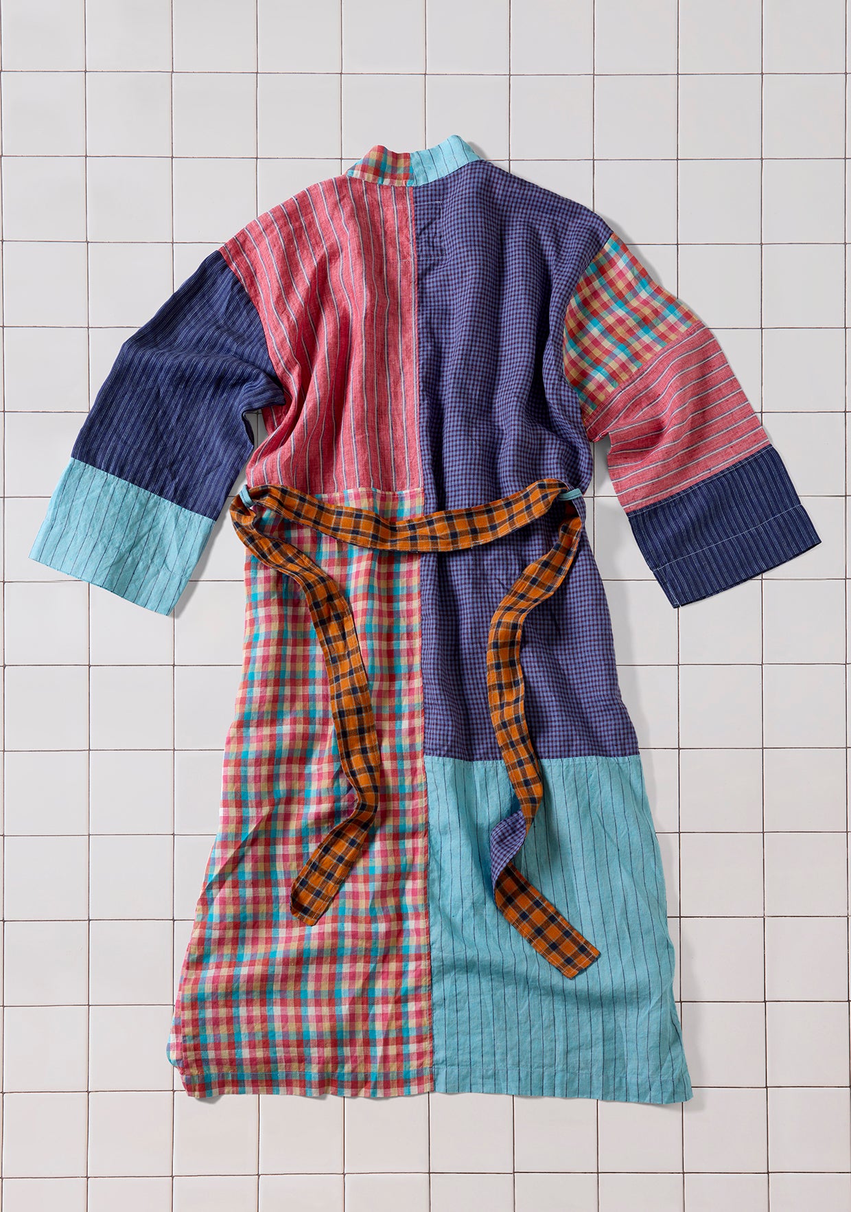 Colorful patchwork robe shot from the back on a tile background