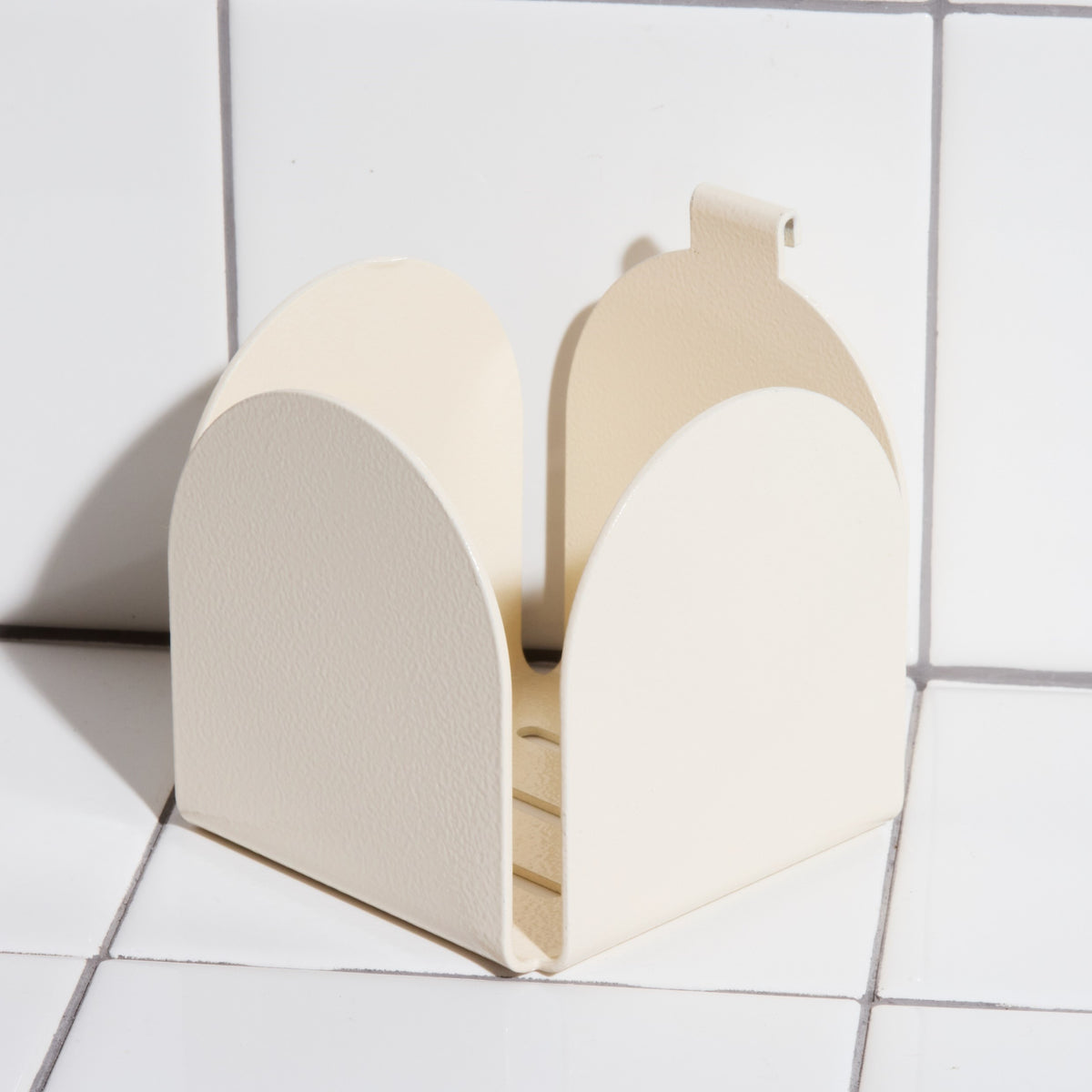 Aluminum basket holder hook in sand.