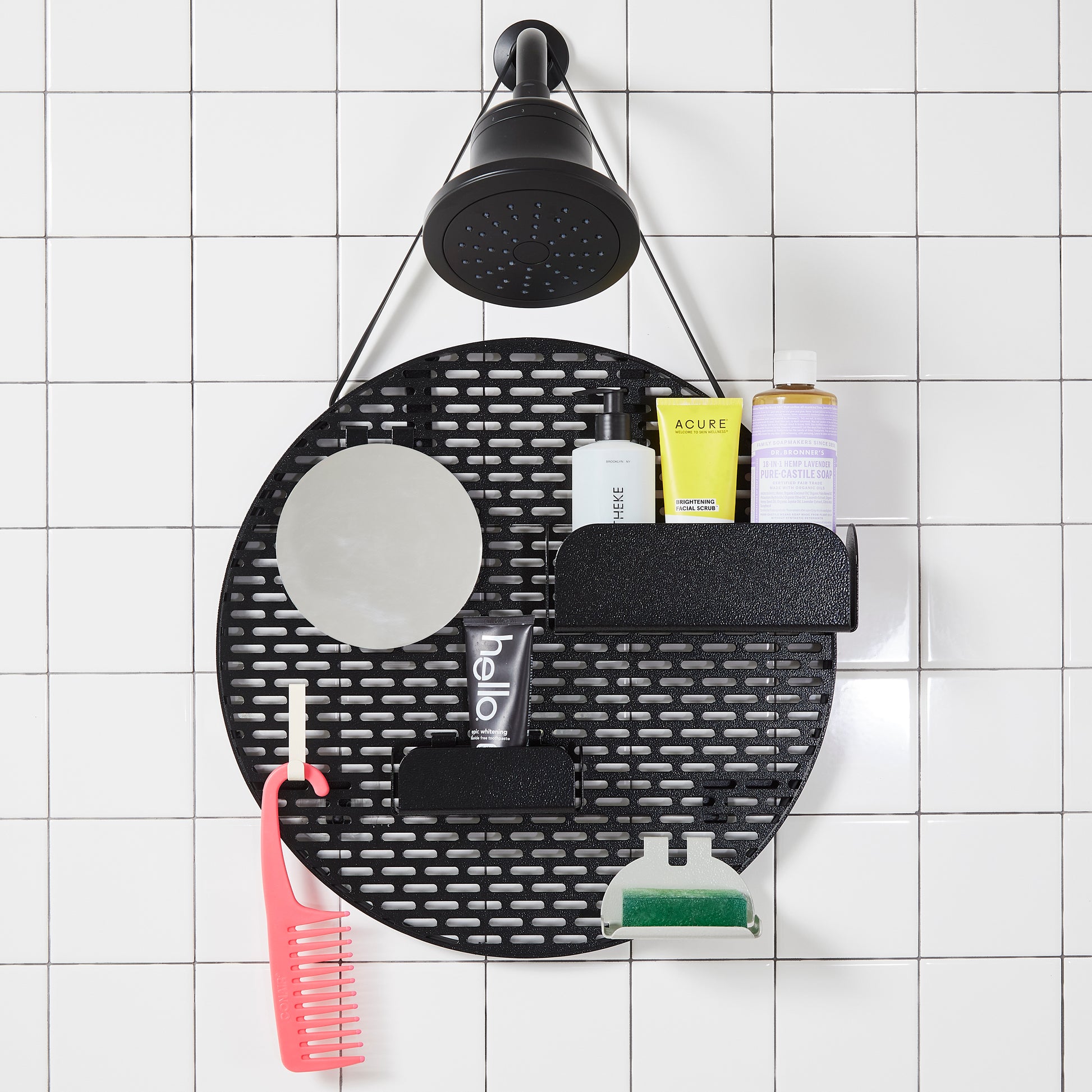 The Spot in Night Ride (black) hanging from a black shower head on a white tiled wall. 