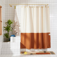 Orient Clay front view of curtain hanging in a bathroom.
