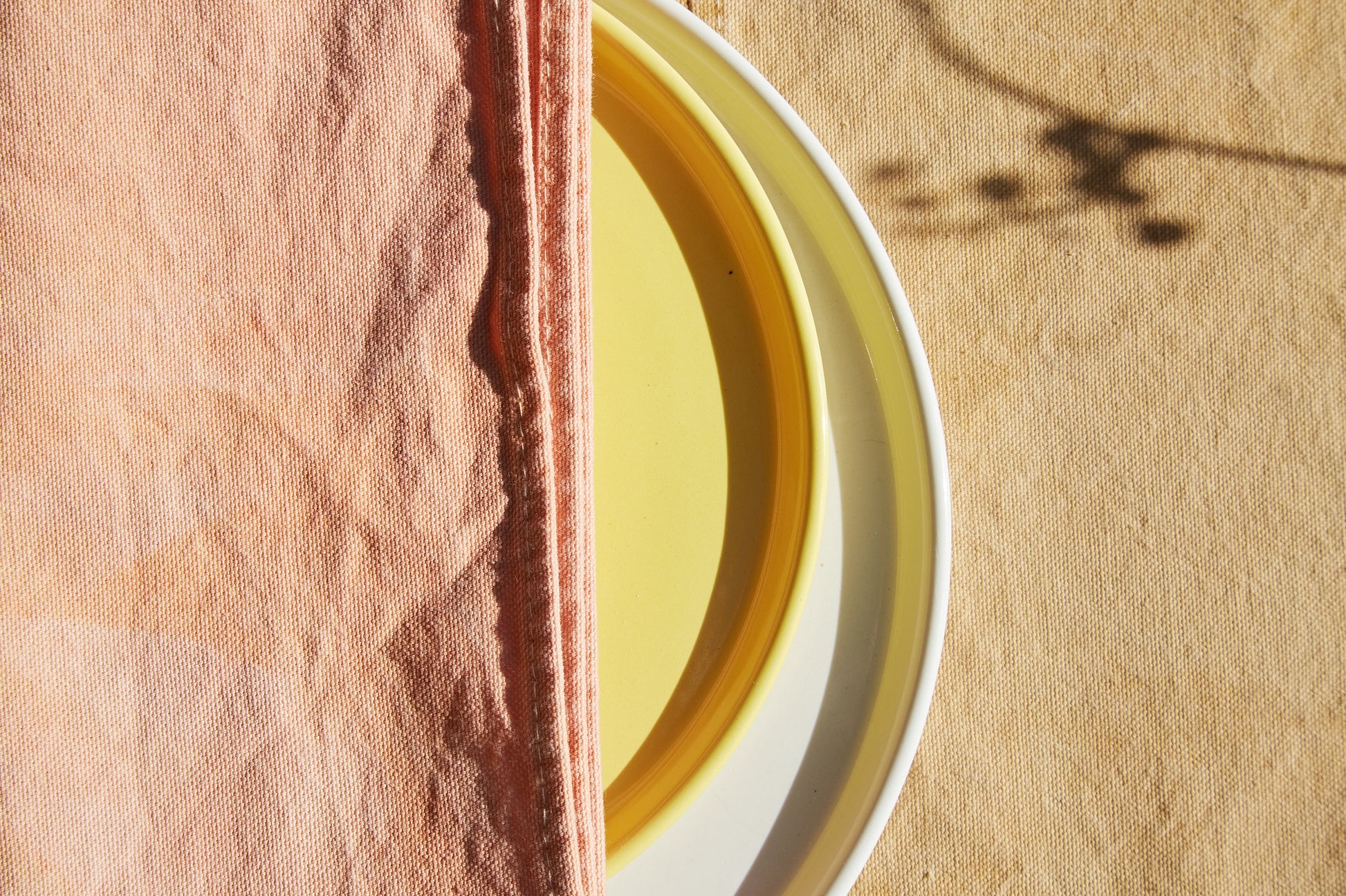 Naturally Dyed Napkins in Madder Root detail view with tableware