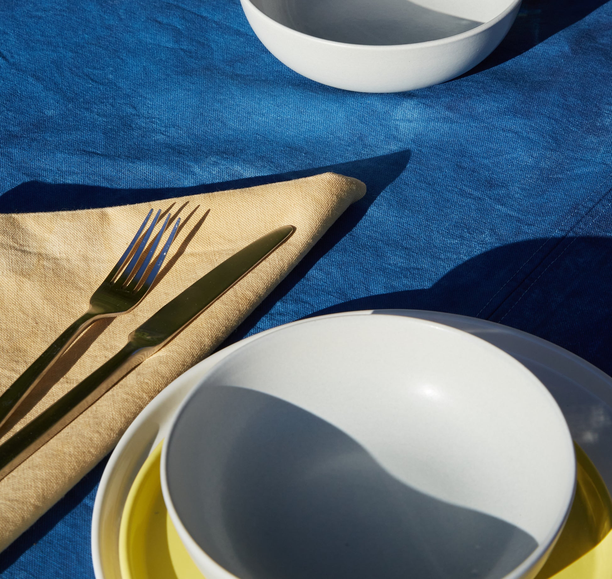Naturally Dyed Napkins in Eucalyptus detail view with tableware